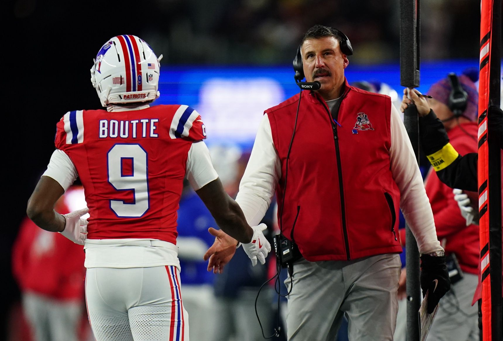 New England Patriots wide receiver Kayshon Boutte (9) high-fives New England Patriots head coach Mike Vrabel on the sideline during the third quarter at Gillette Stadium.
