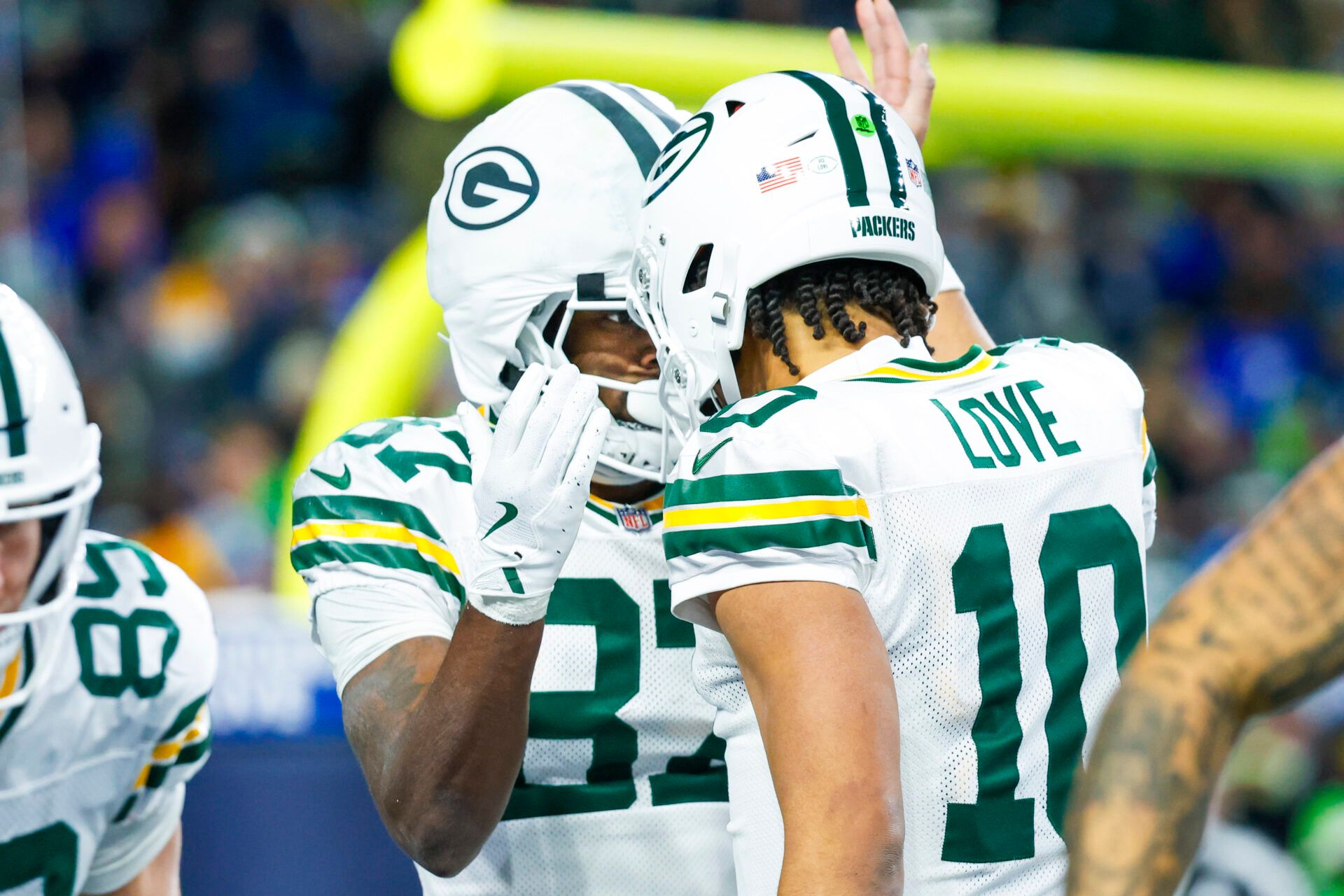 Green Bay Packers wide receiver Romeo Doubs (87) celebrates with Green Bay Packers quarterback Jordan Love (10) following a touchdown pass against the Seattle Seahawks during the fourth quarter at Lumen Field.