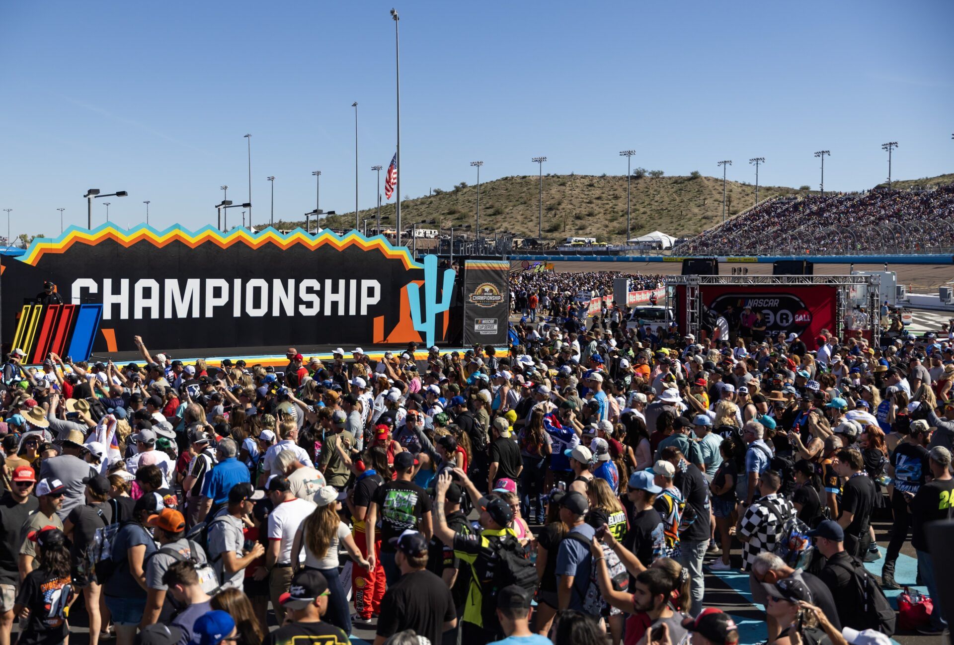 NASCAR Cup Series fans fill the infield during driver introductions prior to the NASCAR Championship race at Phoenix Raceway.