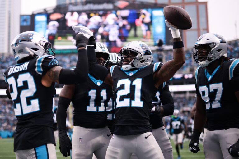 Carolina Panthers safety Nick Scott (21) celebrates after Carolina Panthers cornerback Mike Jackson (2) (not pictured) intercepted a pass to score a touchdown during the first quarter against the Los Angeles Rams at Bank of America Stadium.