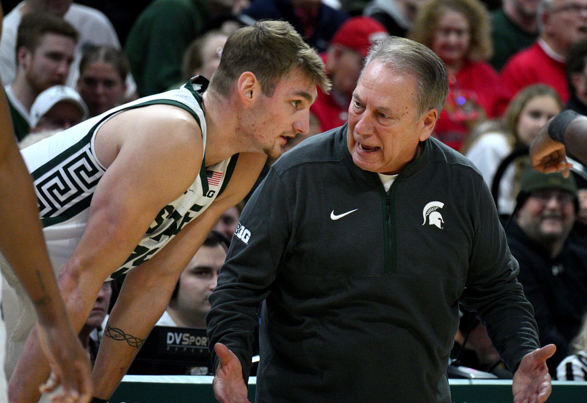 Michigan State Spartans head coach Tom Izzo talks with Michigan State Spartans center Carson Cooper (15) during the first half against the Cornell Big Red at Jack Breslin Student Events Center.