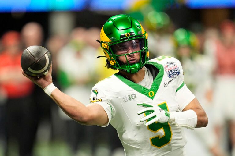 Oregon Ducks quarterback Dante Moore (5) throws a pass during the fourth quarter the 2025 Peach Bowl and semifinal game of the College Football Playoff at Mercedes-Benz Stadium.