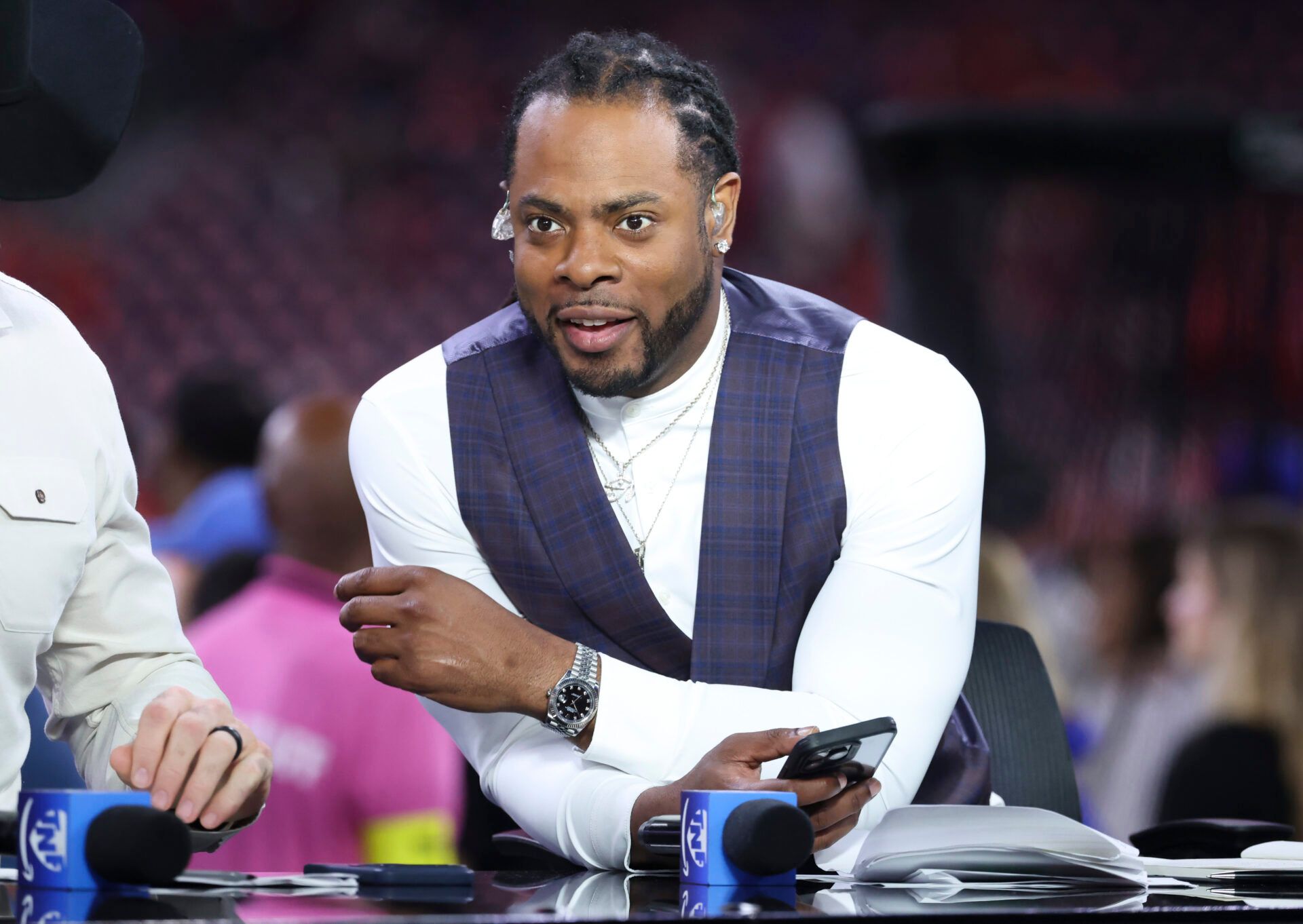 Television analyst Richard Sherman looks on before the game between the Houston Texans and the Buffalo Bills at NRG Stadium.