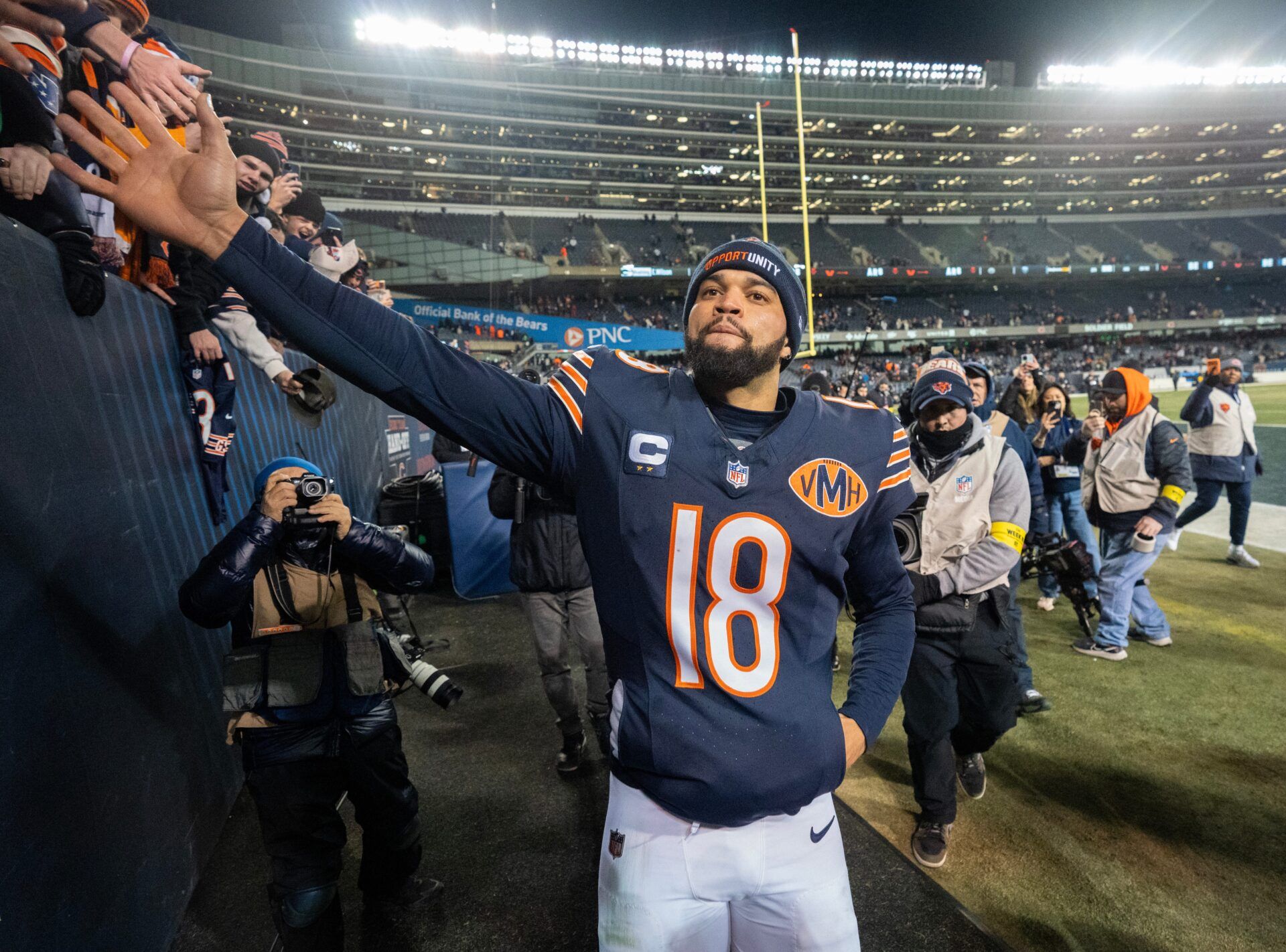 Chicago Bears quarterback Caleb Williams (18) high fives fans after their game Saturday, December 20, 2025 at Soldier Field in Chicago, Illinois. The Chicago Bears beat the Green Bay Packers 22-16 in overtime.