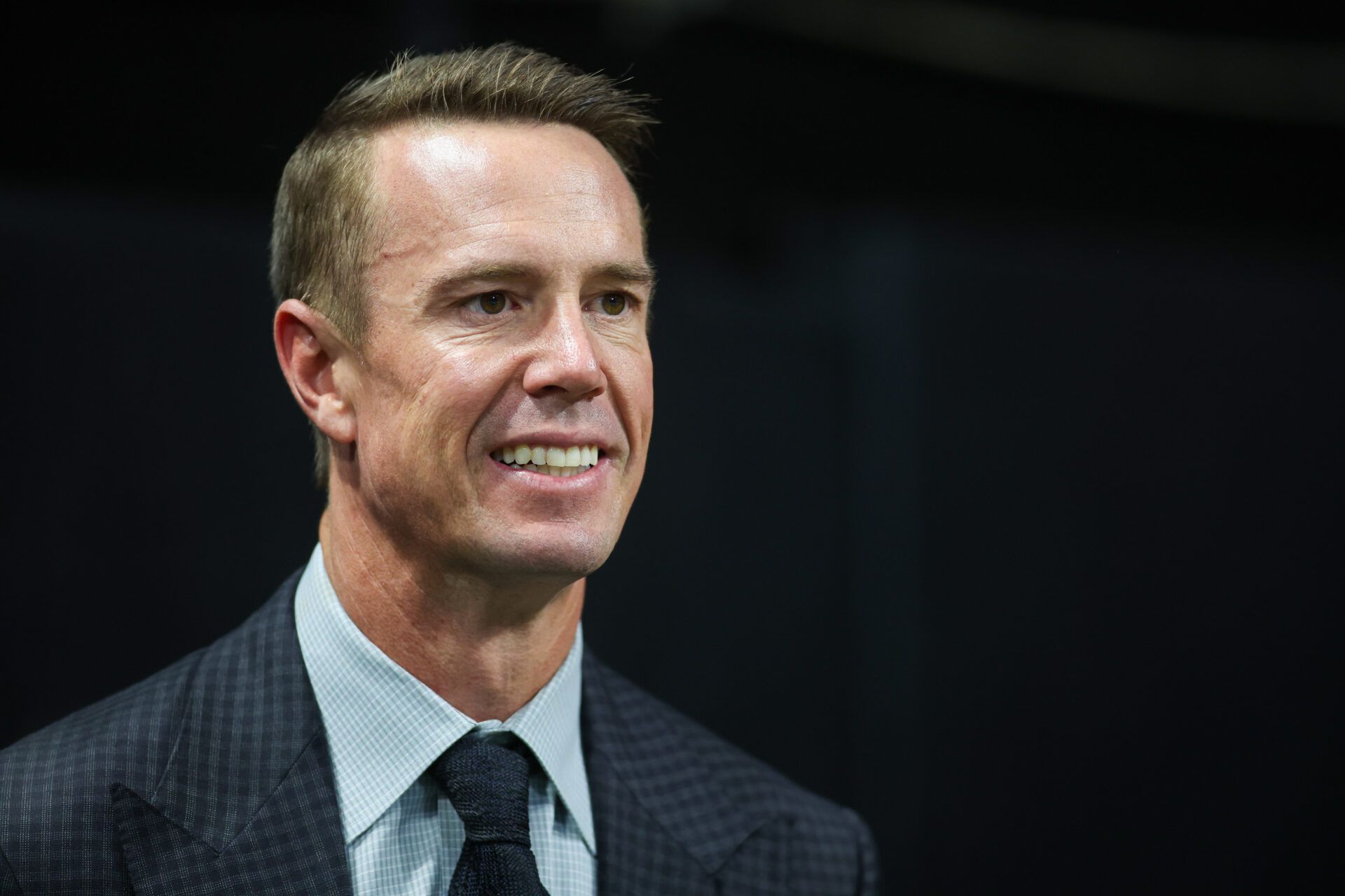 Former Atlanta Falcons quarterback Matt Ryan (2) on the sideline before being inducted in the team’s ring of honor at halftime of a game against the Tampa Bay Buccaneers at Mercedes-Benz Stadium.