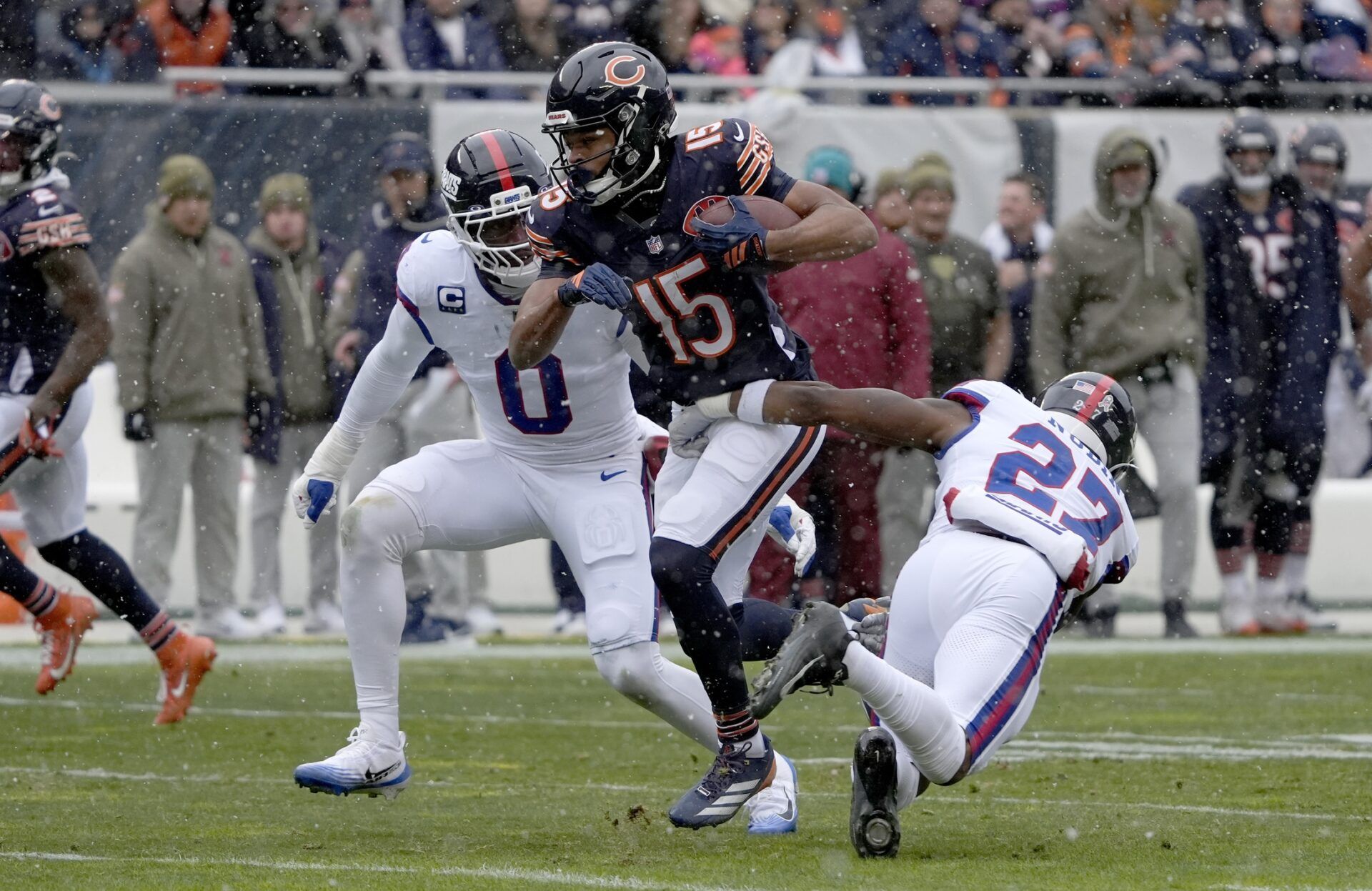 Chicago Bears wide receiver Rome Odunze (15) runs against New York Giants safety Tyler Nubin (27) and linebacker Brian Burns (0) during the first half at Soldier Field.