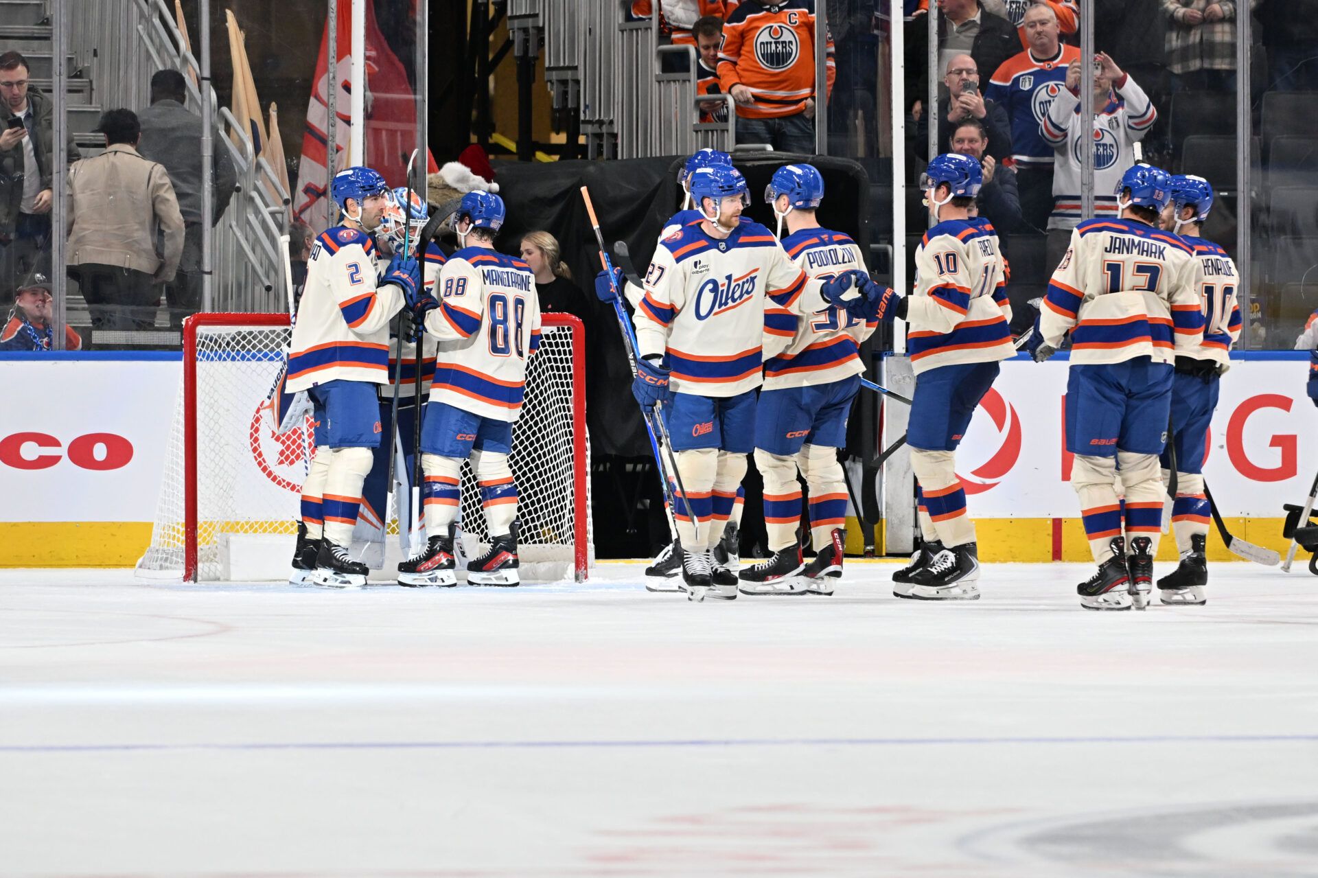 Edmonton Oilers defenseman Evan Bouchard (2) with Oilers left winger Andrew Mangiapane (88) clebrates their win with Edmonton Oilers goalie Calvin Pickard (30) over the Seattle Kraken during the third period at Rogers Place.