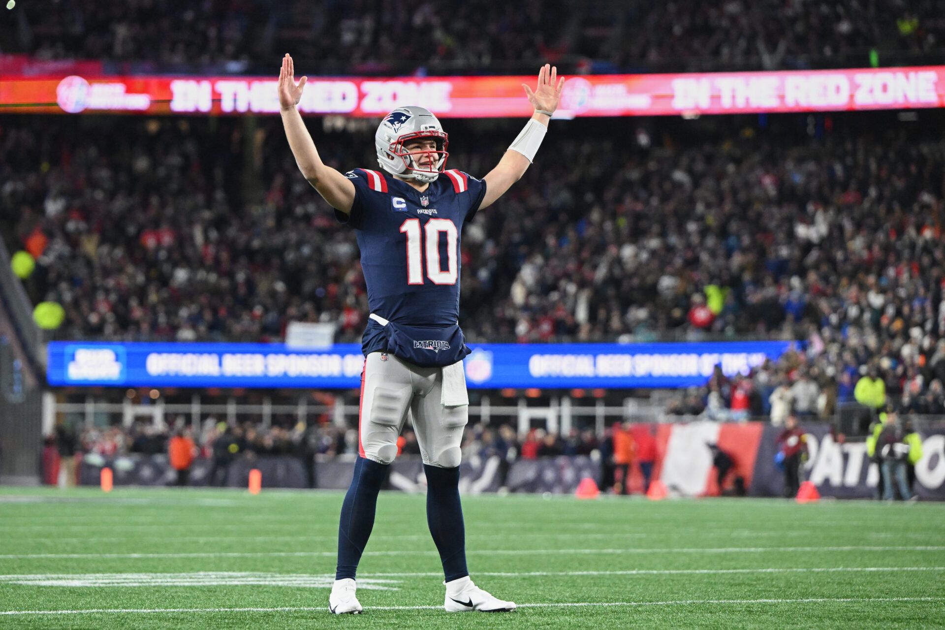 New England Patriots quarterback Drake Maye (10) reacts to a Patriots touchdown scored against the Miami Dolphins during the first quarter at Gillette Stadium.