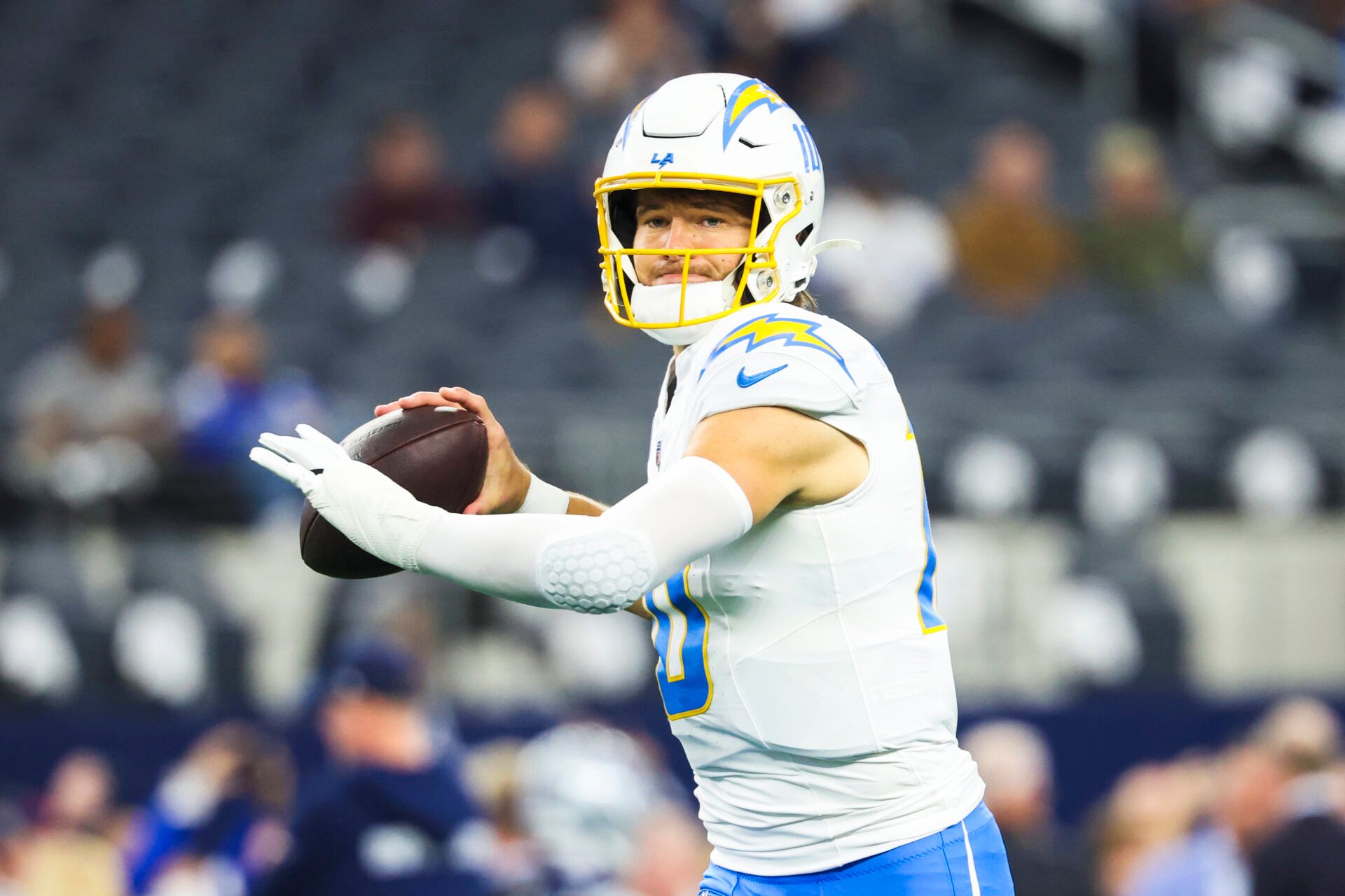 Los Angeles Chargers quarterback Justin Herbert (10) participates in pregame warmups against the Dallas Cowboys at AT&T Stadium.