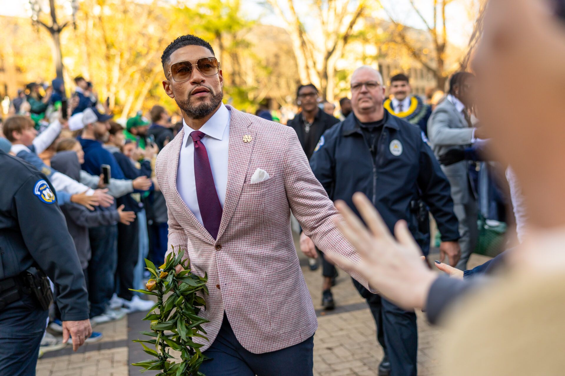 Notre Dame Fighting Irish head coach Marcus Freeman greets fans while walking to the stadium before facing the Syracuse Orange at Notre Dame Stadium.