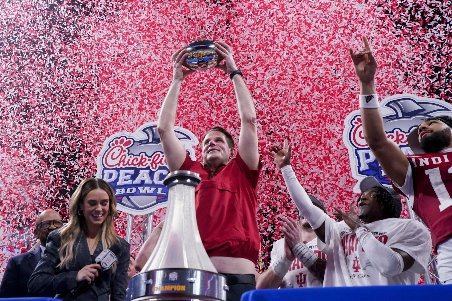 Indiana Hoosiers head coach Curt Cignetti holds up the trophy as confetti falls Friday, Jan. 9, 2026, after defeating the Oregon Ducks in the Peach Bowl and semifinal game of the College Football Playoff at Mercedes-Benz Stadium in Atlanta. Grace Hollars/IndyStar / USA TODAY NETWORK via Imagn Images