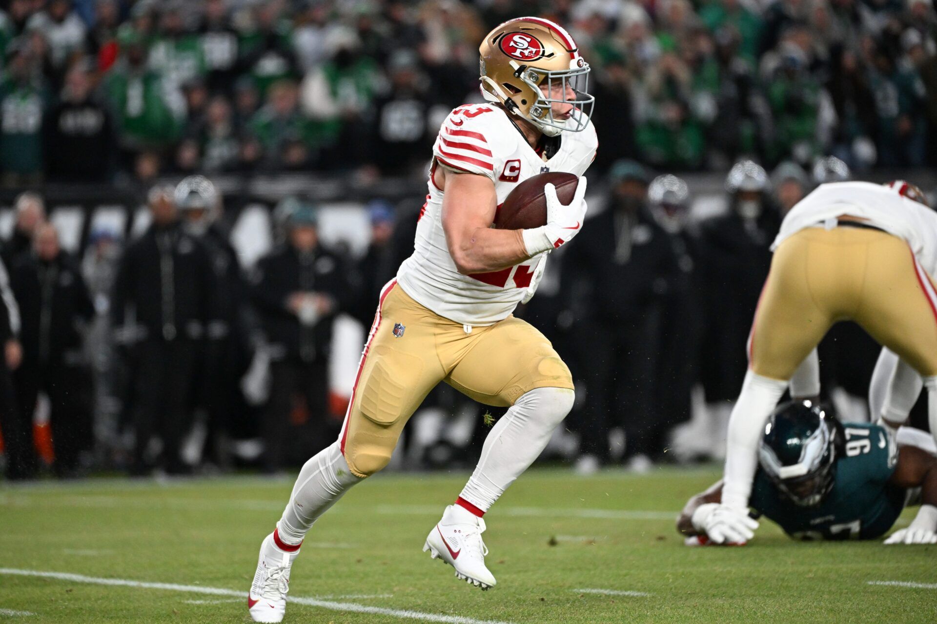 San Francisco 49ers running back Christian McCaffrey (23) carries the ball against the Philadelphia Eagles during the first quarter in an NFC Wild Card Round game at Lincoln Financial Field.