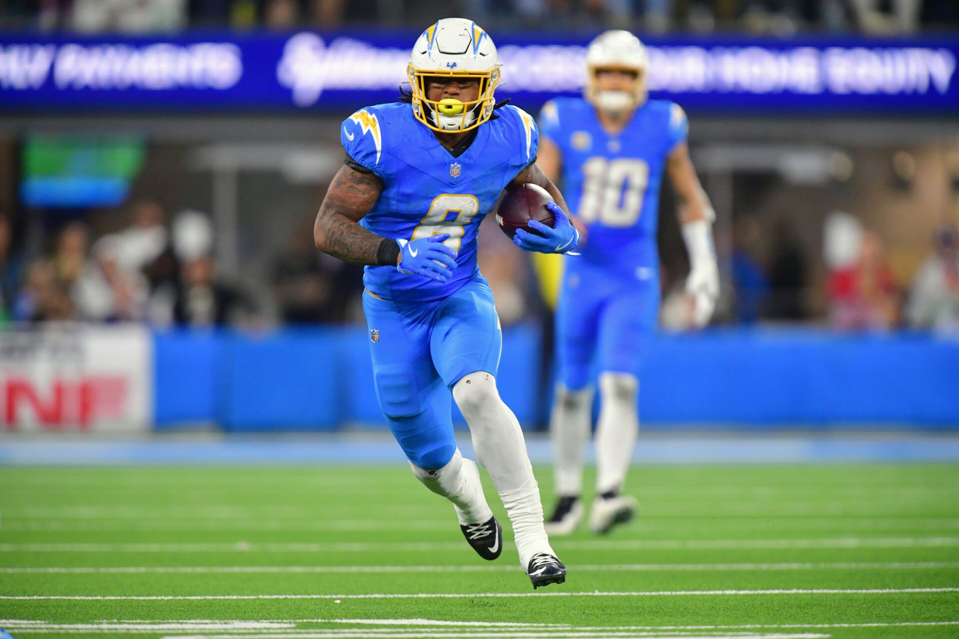 Los Angeles Chargers running back Omarion Hampton (8) runs against the Philadelphia Eagles in overtime at SoFi Stadium.