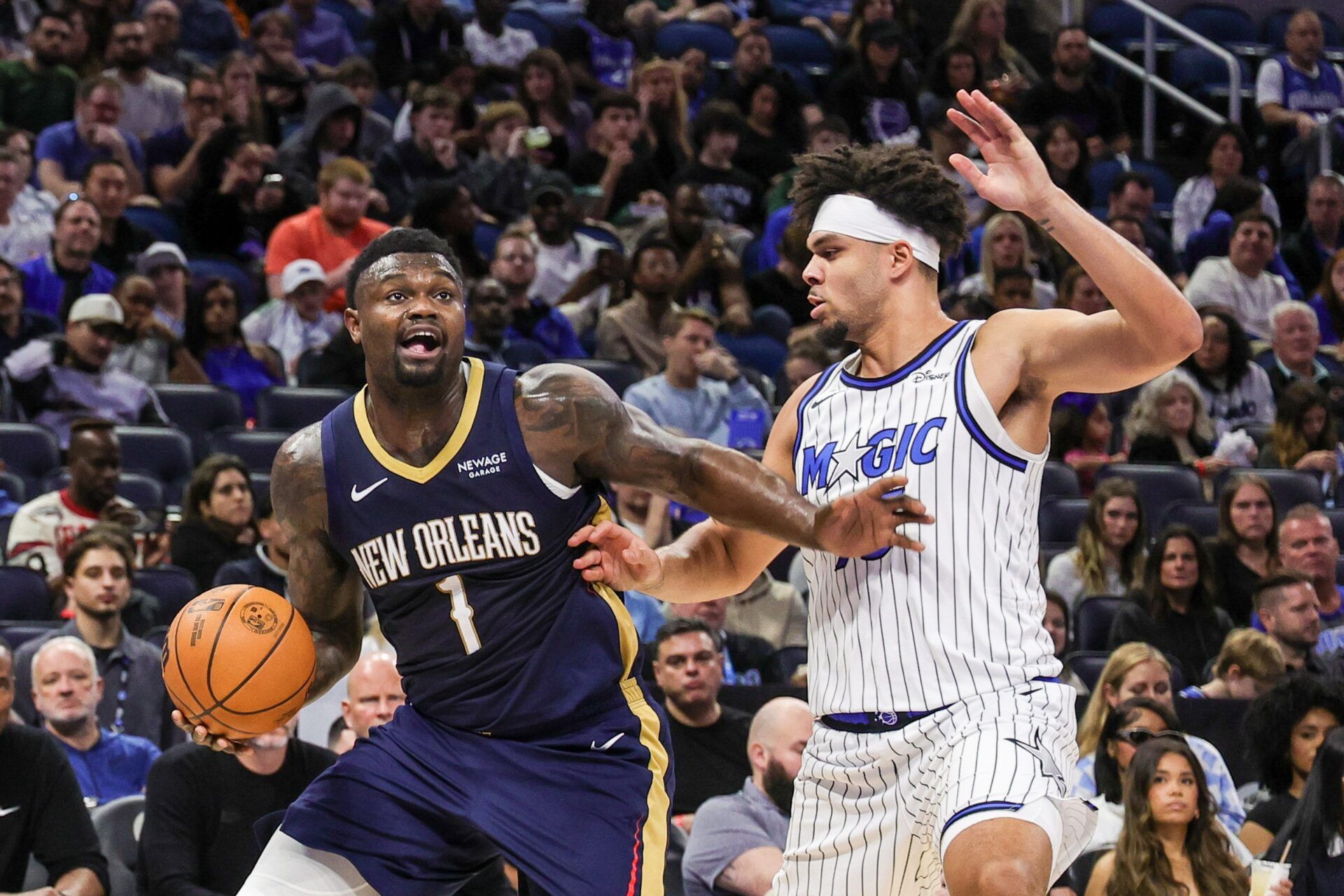 New Orleans Pelicans forward Zion Williamson (1) drives to the basket against Orlando Magic forward Noah Penda (93) during the second quarter at Kia Center.