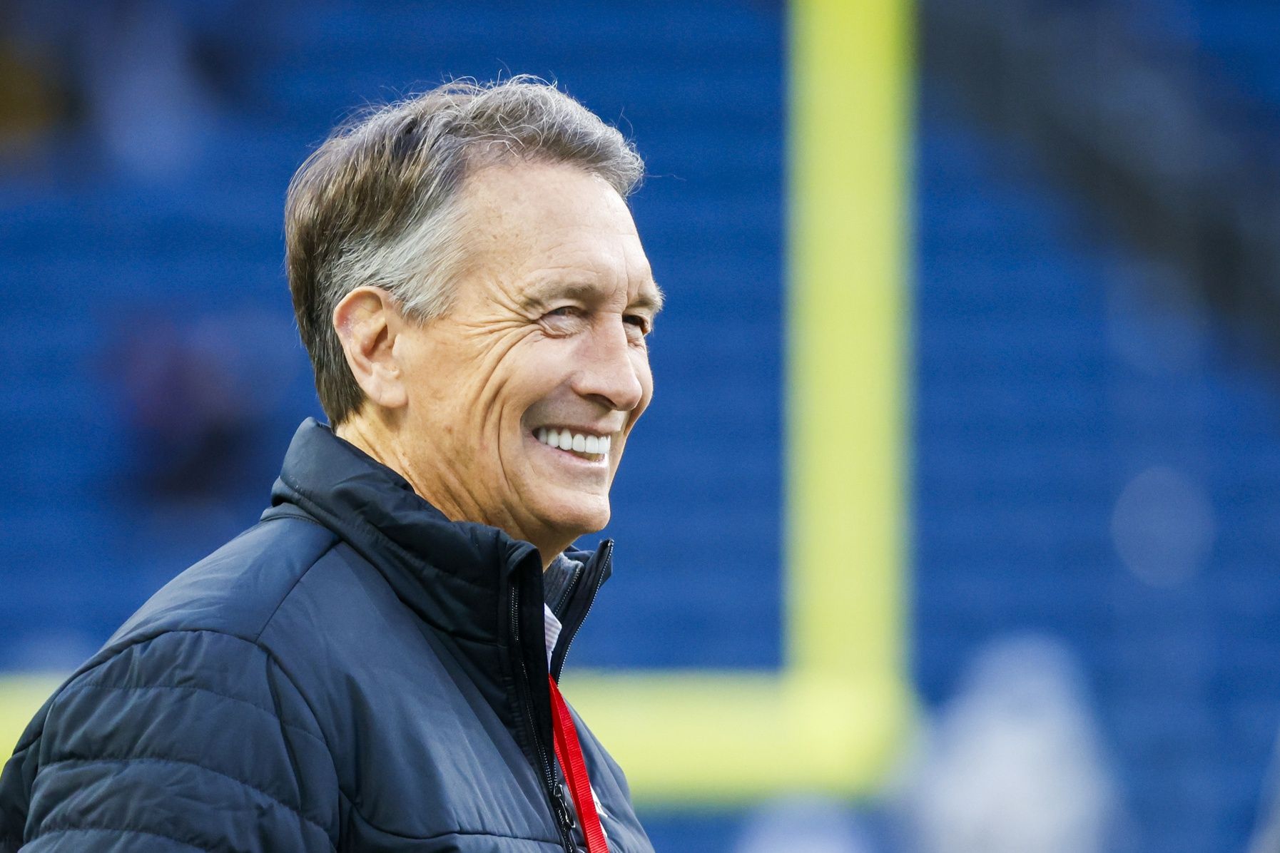 NBC football commentator Chris Collinsworth watches pregame warmups between the Green Bay Packers and Seattle Seahawks at Lumen Field.