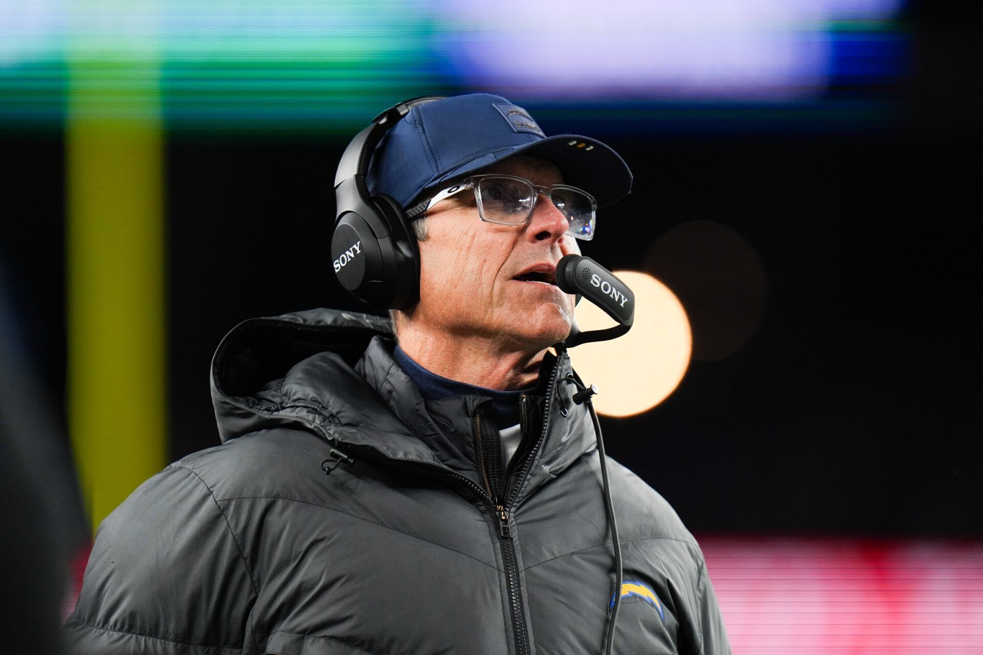 Los Angeles Chargers head coach Jim Harbaugh looks on during the first quarter against the New England Patriots in an AFC Wild Card Round game at Gillette Stadium.