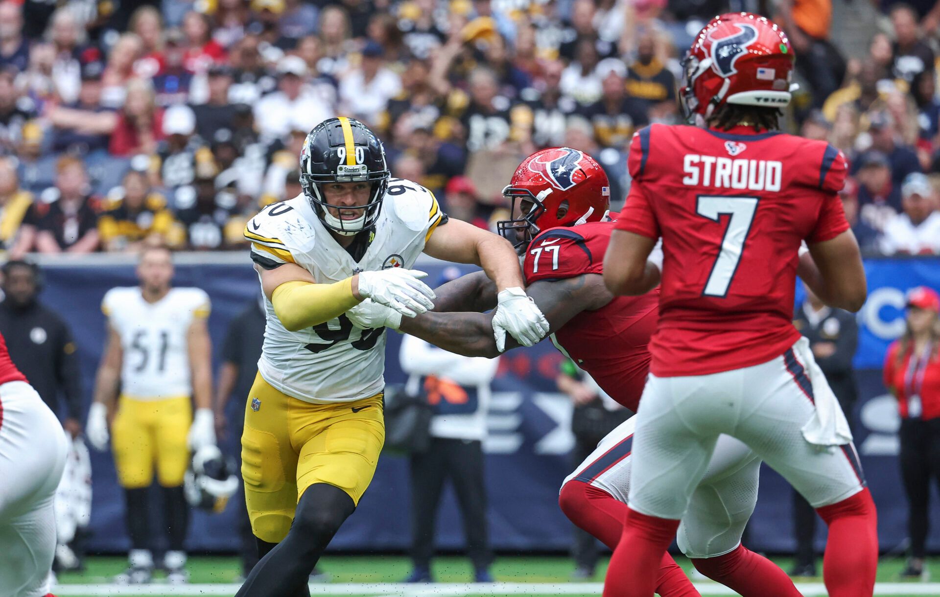 Houston Texans offensive tackle George Fant (77) attempts to block Pittsburgh Steelers linebacker T.J. Watt (90) as Texans quarterback C.J. Stroud (7) looks for an open receiver during the third quarter at NRG Stadium.
