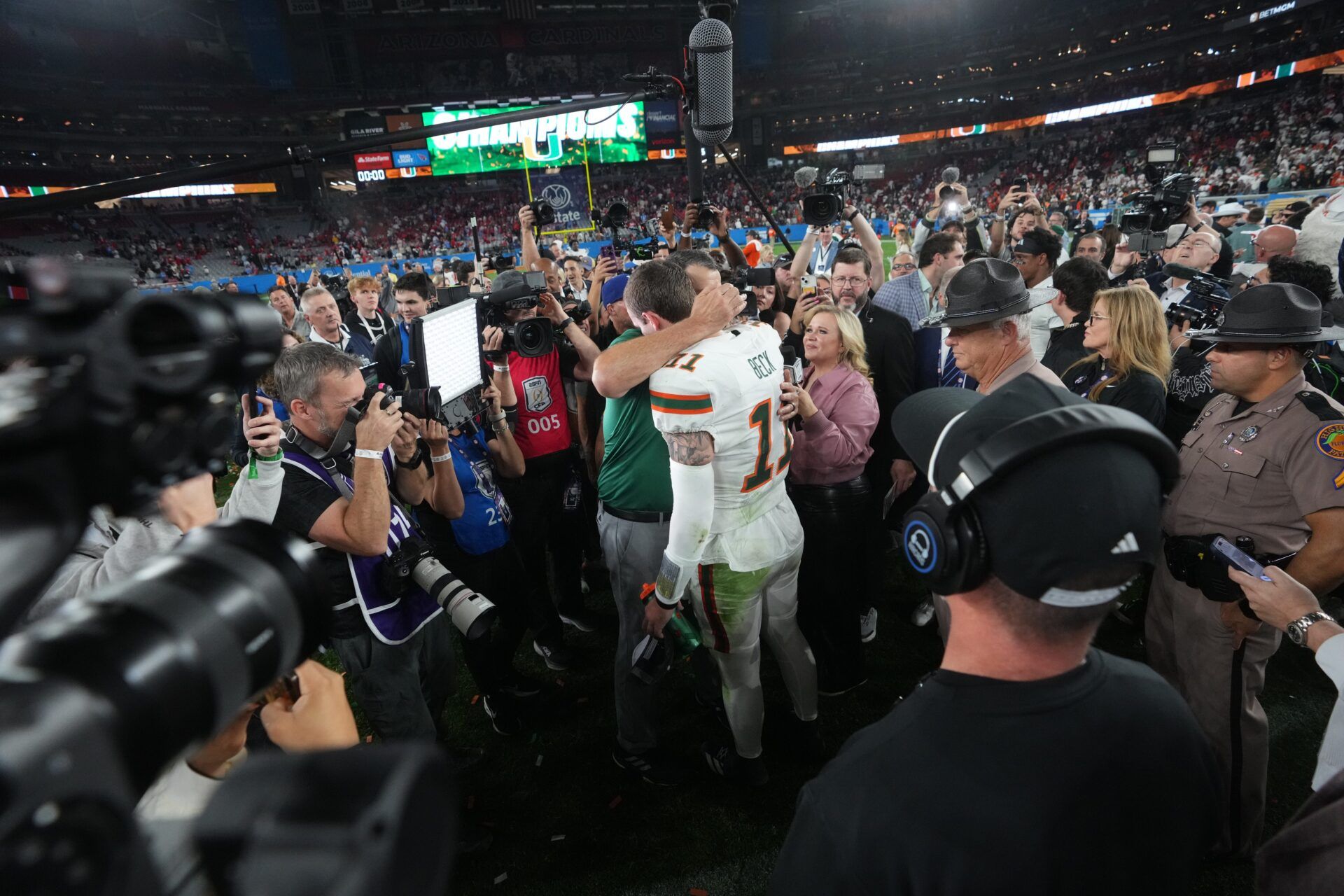 Miami Hurricanes head coach Mario Cristobal hugs quarterback Carson Beck after their 31-27 Vrbo Fiesta Bowl over the Ole Miss Rebels at State Farm Stadium on Jan. 8, 2026.