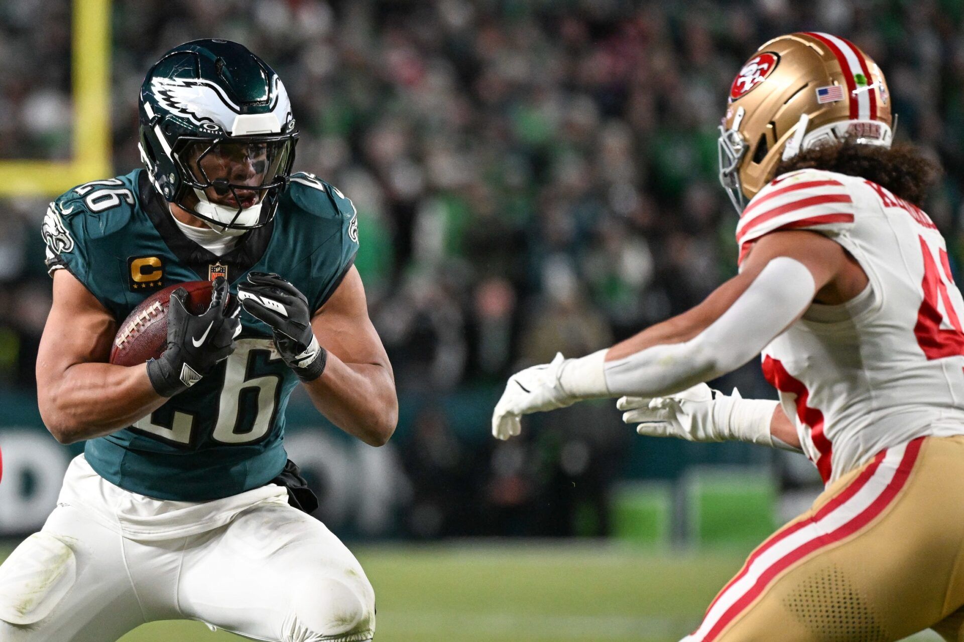 Philadelphia Eagles running back Saquon Barkley (26) carries the ball defended by San Francisco 49ers linebacker Eric Kendricks (43) during the second quarter in an NFC Wild Card Round game at Lincoln Financial Field.