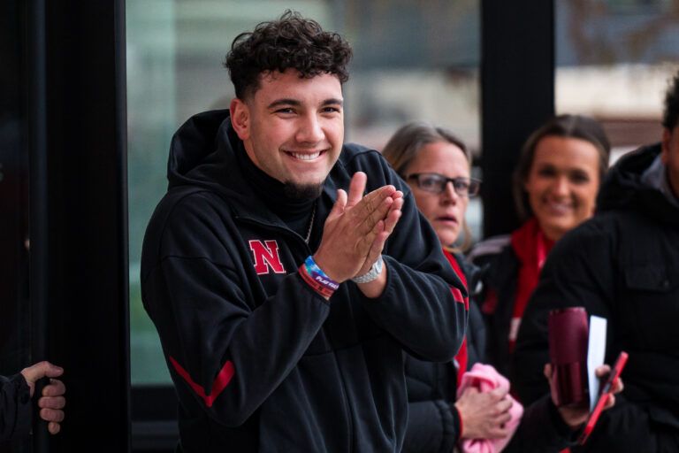 Nebraska Cornhuskers quarterback Dylan Raiola (15) greets the team as the walk into the stadium before the game against the Iowa Hawkeyes at Memorial Stadium.