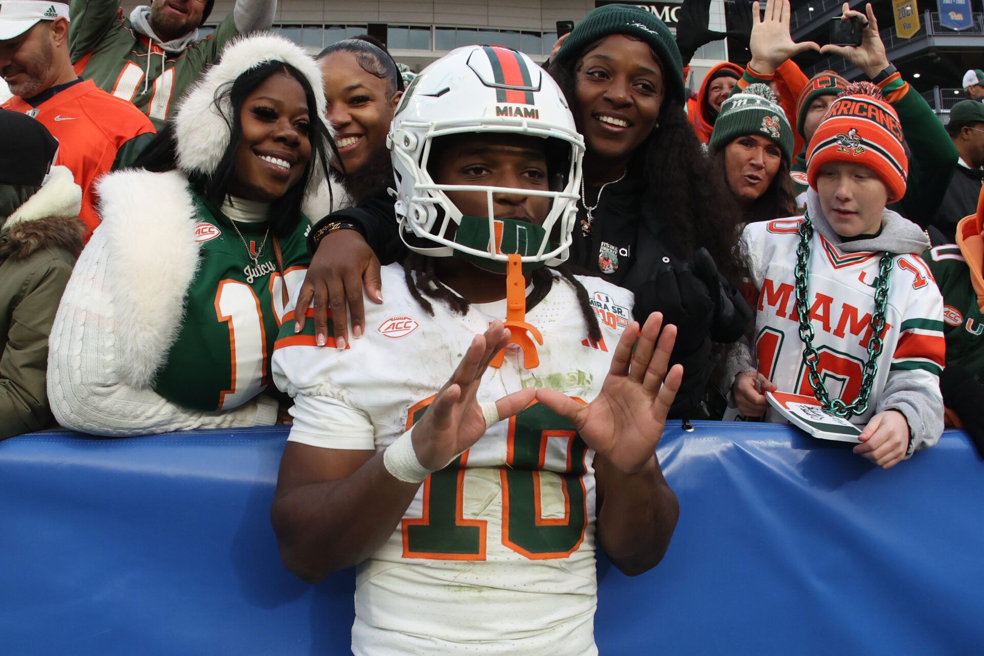 Miami Hurricanes wide receiver Malachi Toney (10) celebrates with family and friends after defeating the Pittsburgh Panthers at Acrisure Stadium.