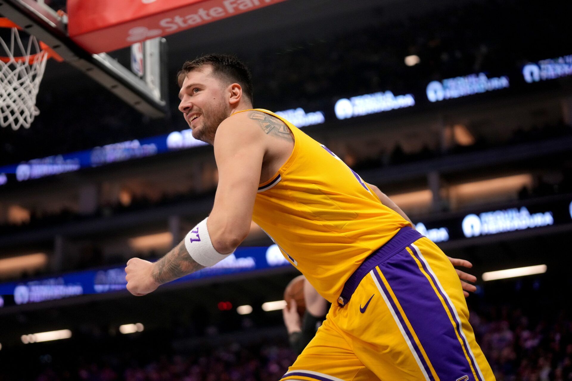 Los Angeles Lakers guard Luka Doncic (77) looks towards the team bench after scoring against the Sacramento Kings in the second quarter at the Golden 1 Center.