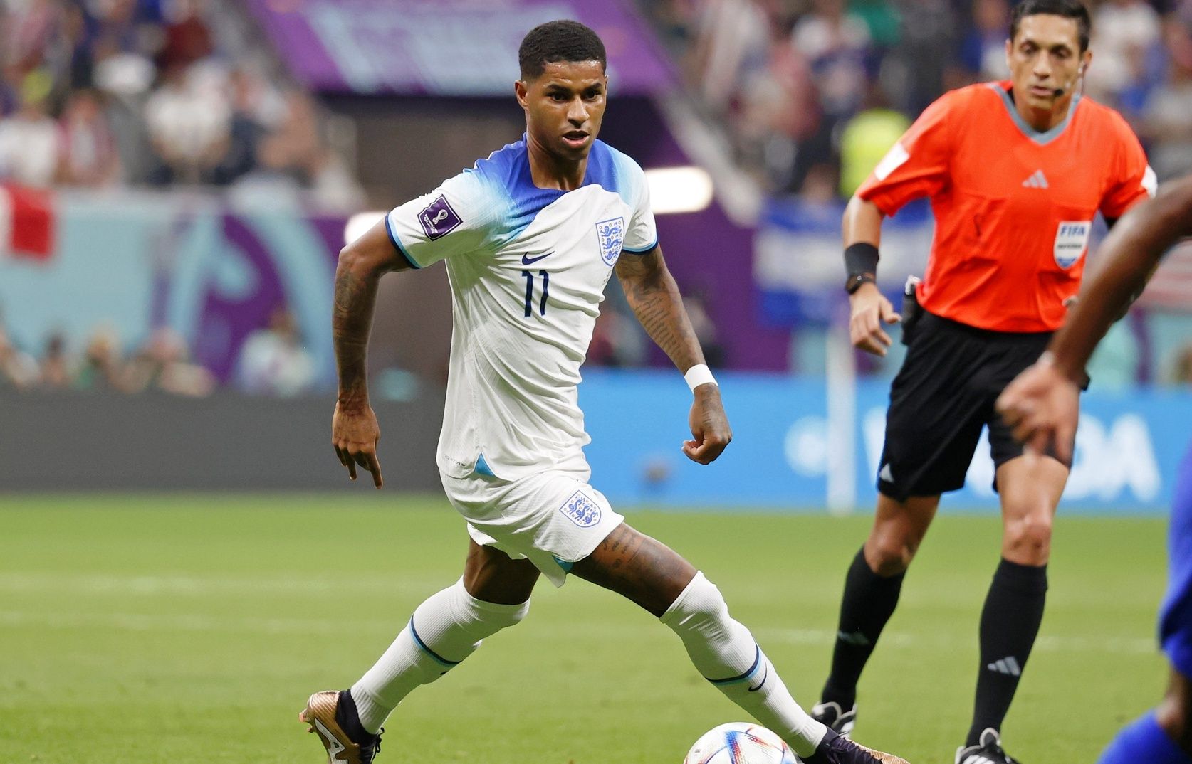 England forward Marcus Rashford (11) dribbles the ball against the United States of America during the second half of a group stage match during the 2022 World Cup at Al Bayt Stadium.