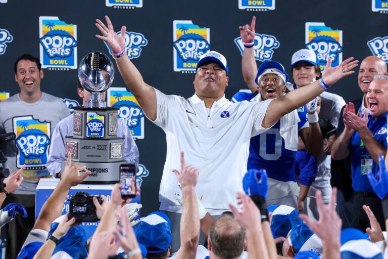 BYU Cougars head coach Kalani Sitake celebrates after beating Georgia Tech Yellow Jackets in the Pop-Tarts Bowl at Camping World Stadium.
