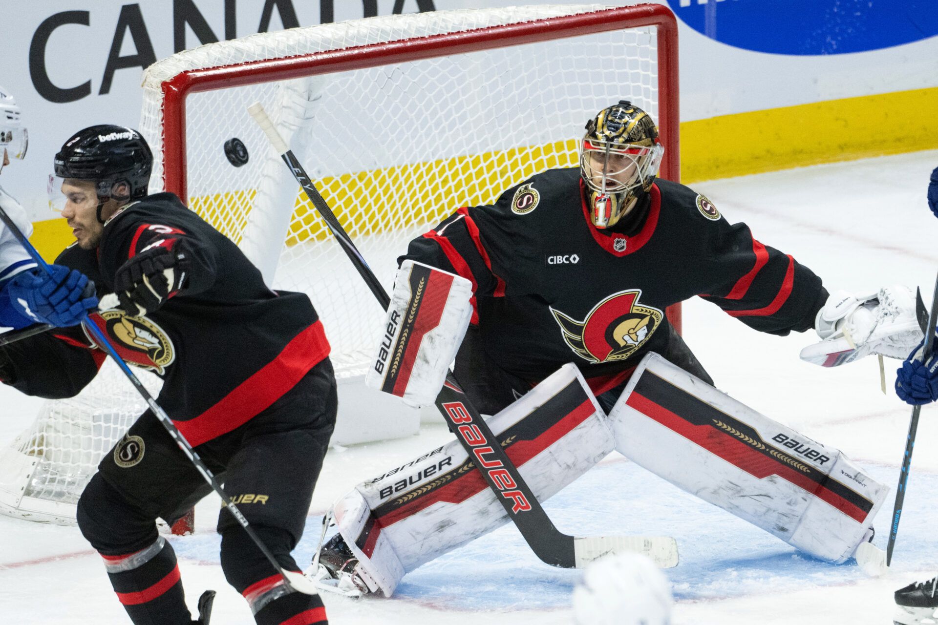 Ottawa Senators goalie Leevi Merilainen (1) follows the puck after making a save in the third period against the Vancouver Canucks at the Canadian Tire Centre.