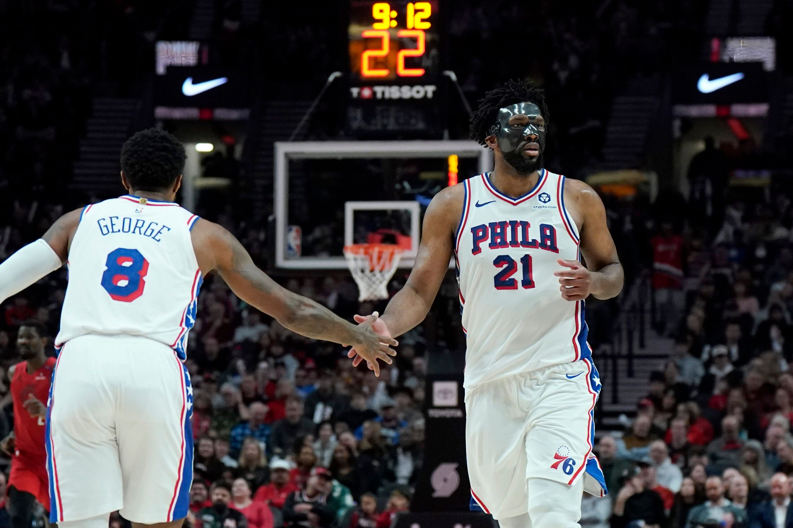 Philadelphia 76ers center Joel Embiid (21) and forward Paul George (8) high five during the second half against the Portland Trail Blazers at Moda Center.