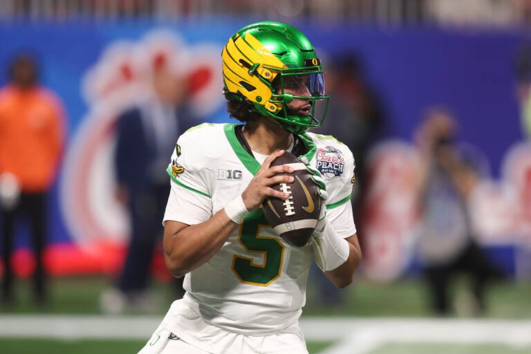 Oregon Ducks quarterback Dante Moore (5) looks to pass against the Indiana Hoosiers during the first half of the 2025 Peach Bowl and semifinal game of the College Football Playoff at Mercedes-Benz Stadium.