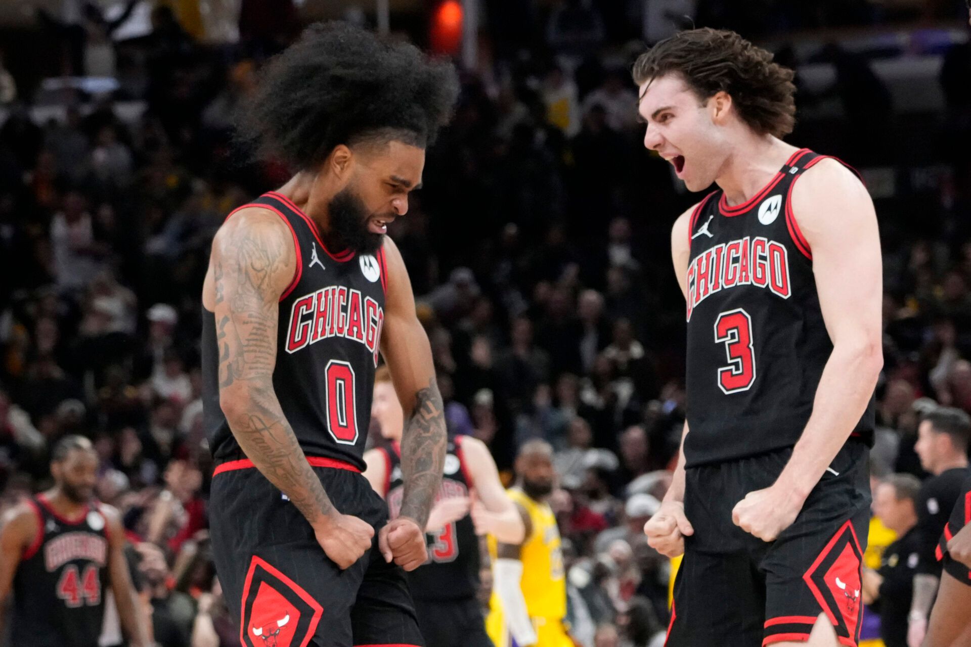 Chicago Bulls guard Coby White (0) celebrates his three point basket against the Los Angeles Lakers with guard Josh Giddey (3) during the second half at United Center.