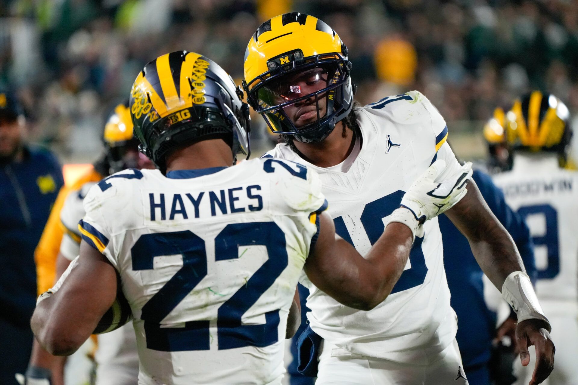 Michigan Wolverines running back Justice Haynes (22) reacts with quarterback Bryce Underwood (19) after scoring a touchdown against the Michigan Wolverines during the second half at Spartan Stadium.