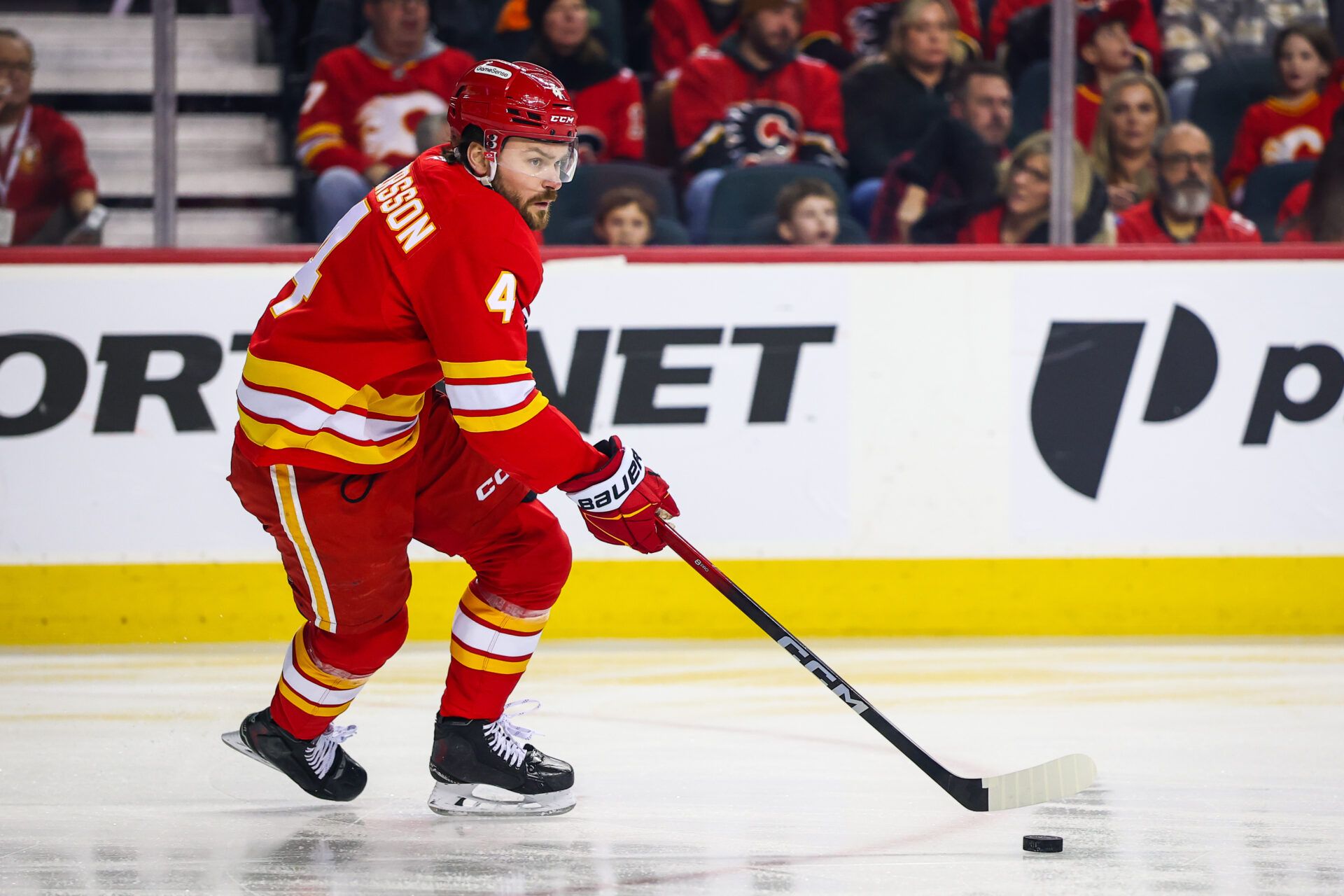 Calgary Flames defenseman Rasmus Andersson (4) skates with the puck against the Nashville Predators during the first period at Scotiabank Saddledome.