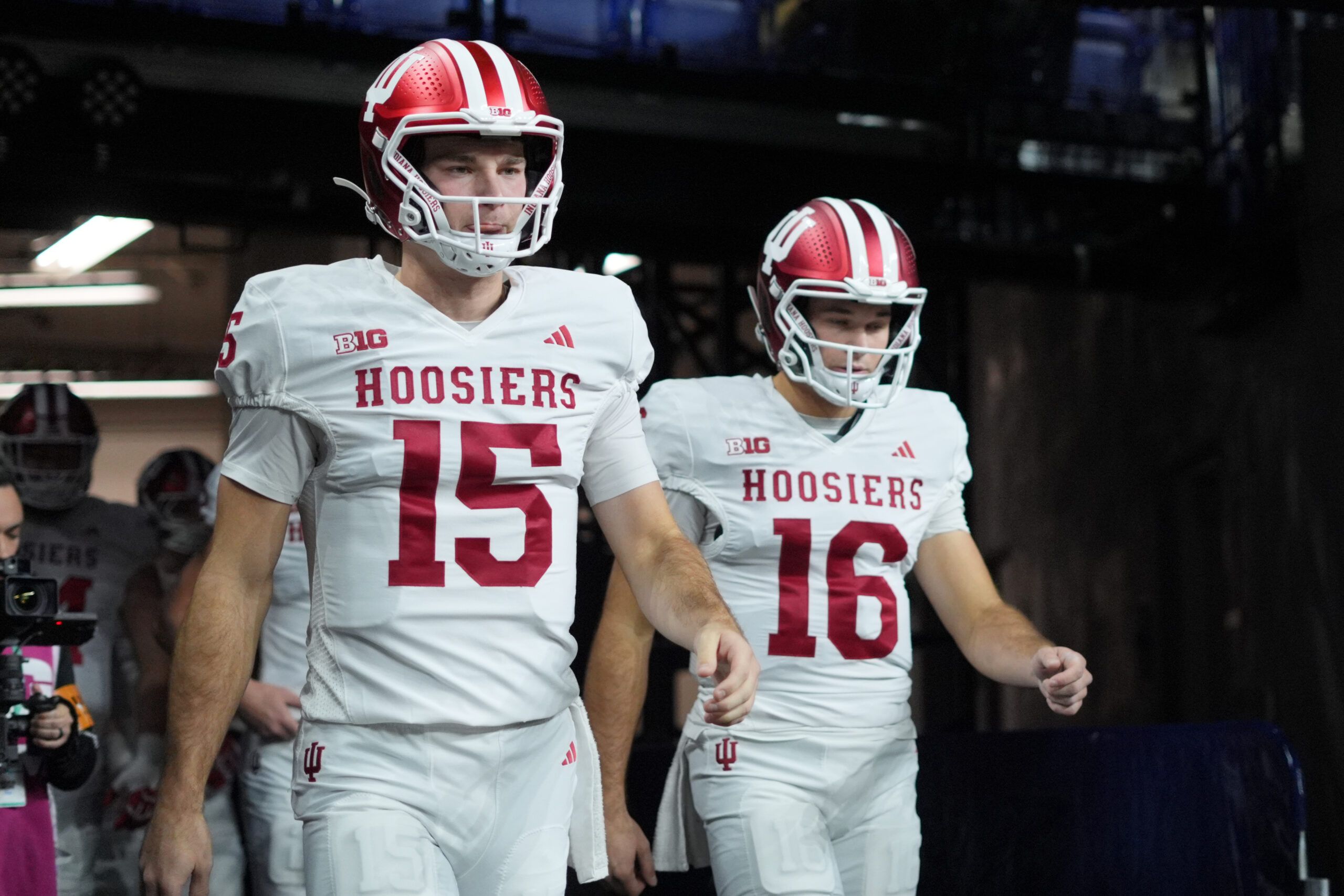 Indiana Hoosiers quarterback Fernando Mendoza (15) and quarterback Alberto Mendoza (16) walk on field for warm ups before the 2025 Big Ten championship game against the Ohio State Buckeyes at Lucas Oil Stadium.