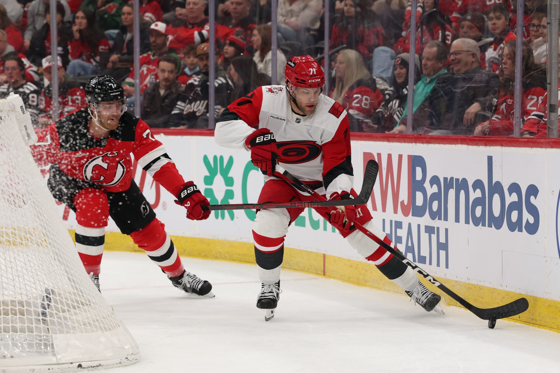 Carolina Hurricanes left wing Taylor Hall (71) skates with the puck as New Jersey Devils defenseman Dougie Hamilton (7) defends during the first period at Prudential Center.