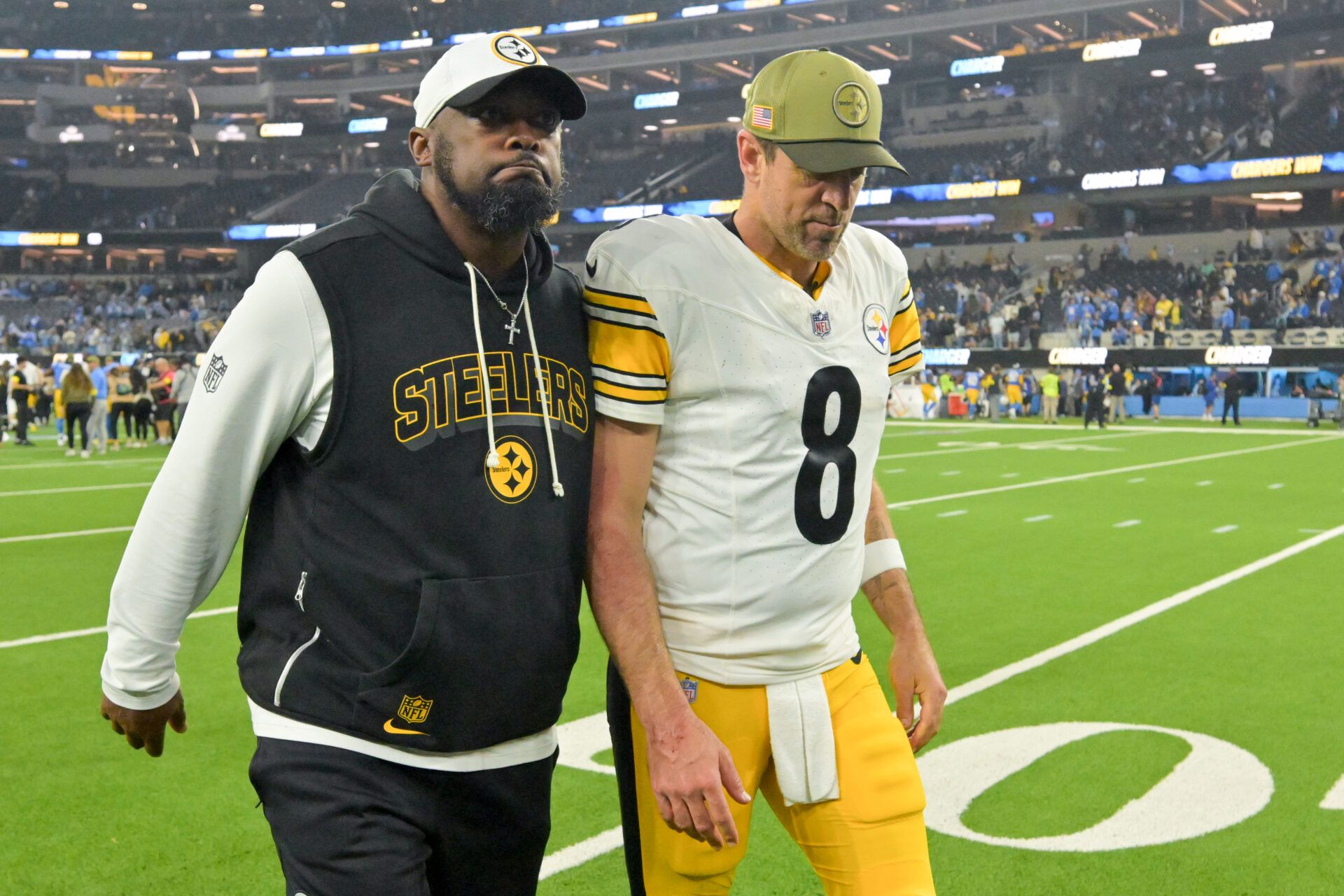 Pittsburgh Steelers head coach Mike Tomlin and quarterback Aaron Rodgers (8) walk off the field after the game against the Los Angeles Chargers at SoFi Stadium.