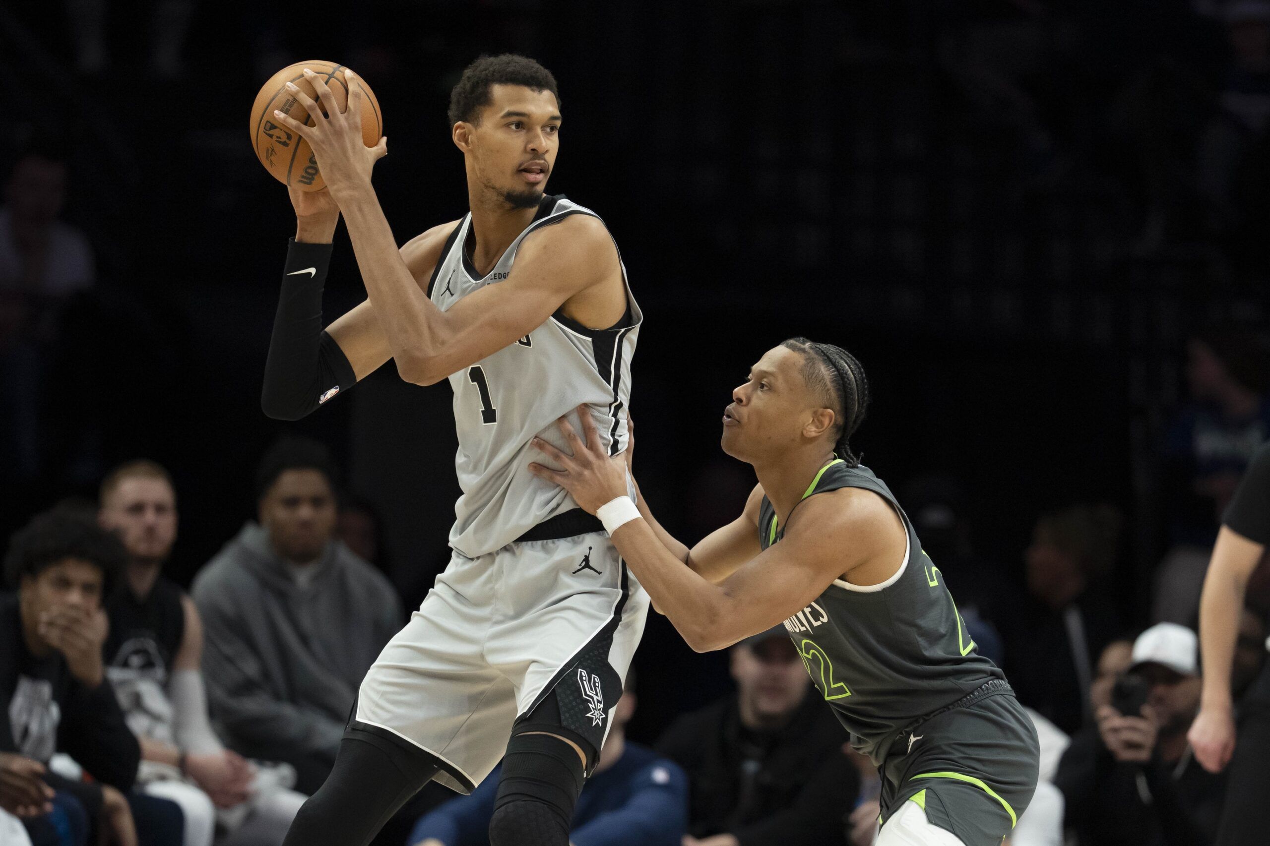 San Antonio Spurs forward Victor Wembanyama (1) holds the ball as Minnesota Timberwolves guard Jaylen Clark (22) plays defense in the second half at Target Center.