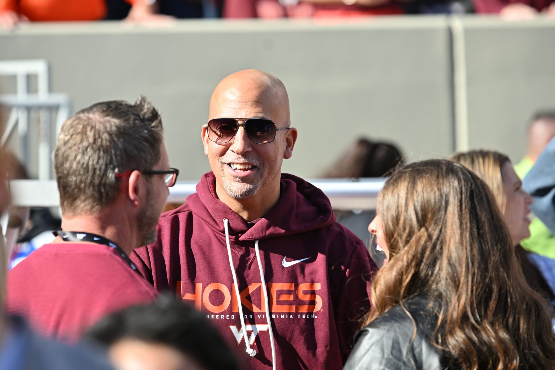 Incoming head coach James Franklin speaks to fans on the sideline before the game at Lane Stadium.