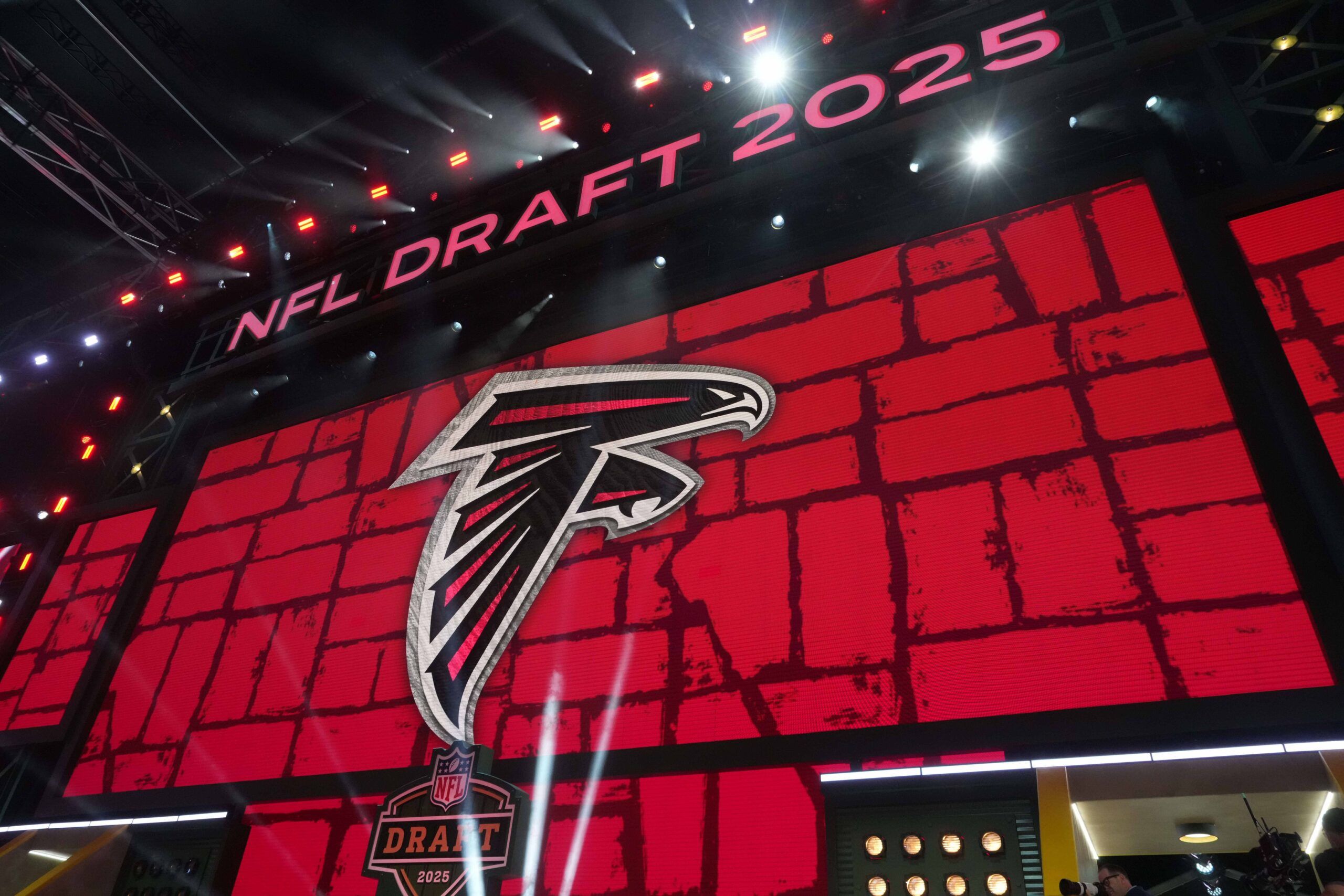 The Atlanta Falcons logo is projected on the video board during the NFL Draft at Lambeau Field.