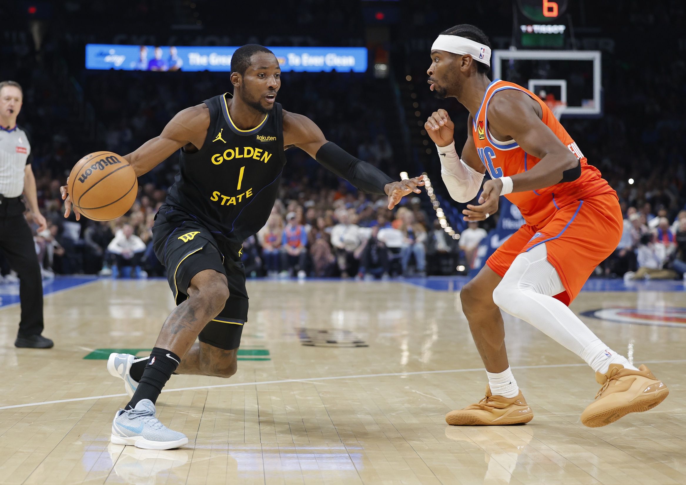 Golden State Warriors forward Jonathan Kuminga (1) moves the ball down the court beside Oklahoma City Thunder guard Shai Gilgeous-Alexander (2) during the second half at Paycom Center.