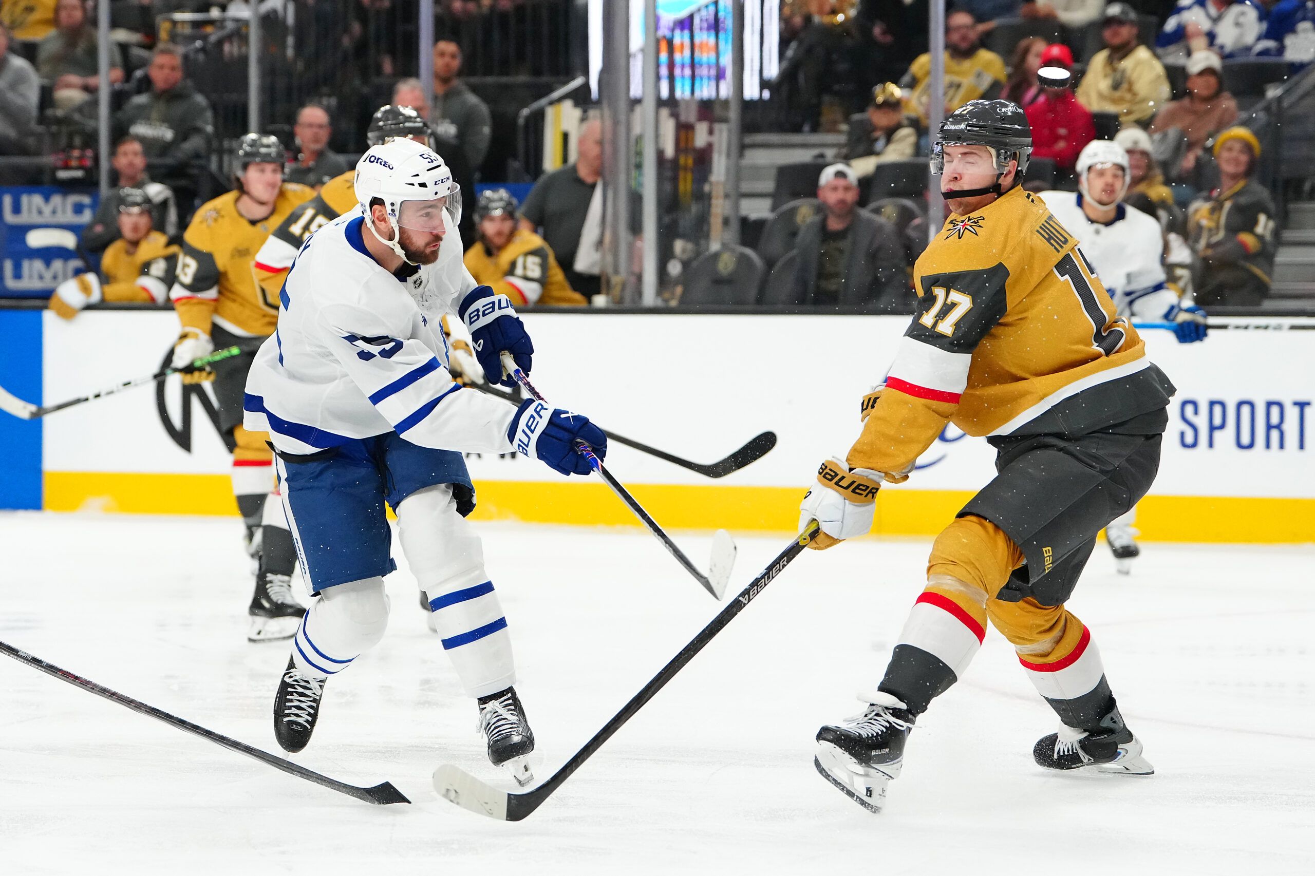 Vegas Golden Knights defenseman Ben Hutton (17) deflects a shot attempt by Toronto Maple Leafs center Nicolas Roy (55) during the third period at T-Mobile Arena.