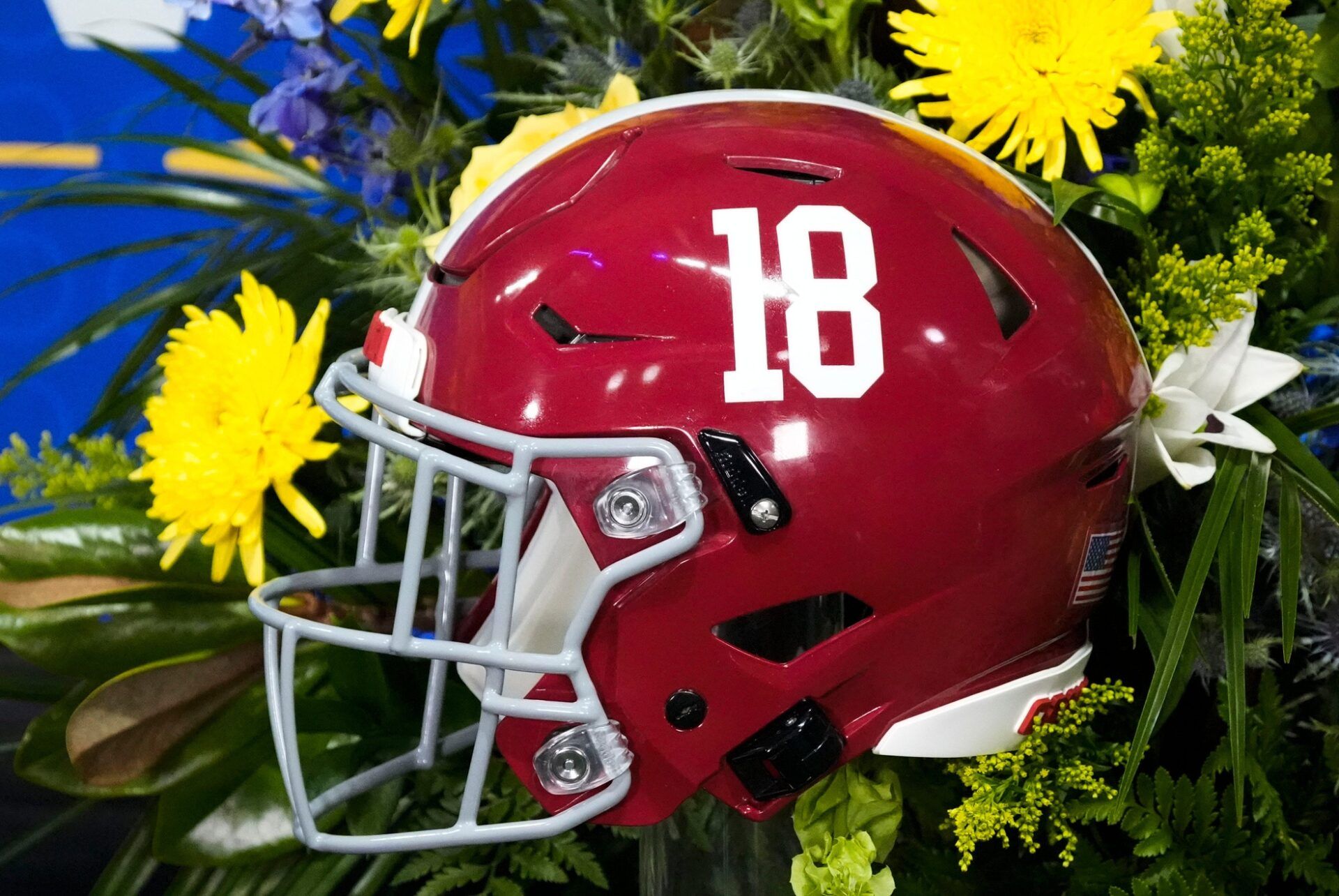 An Alabama football helmet is displayed on a TV set at Mercedes-Benz Stadium.