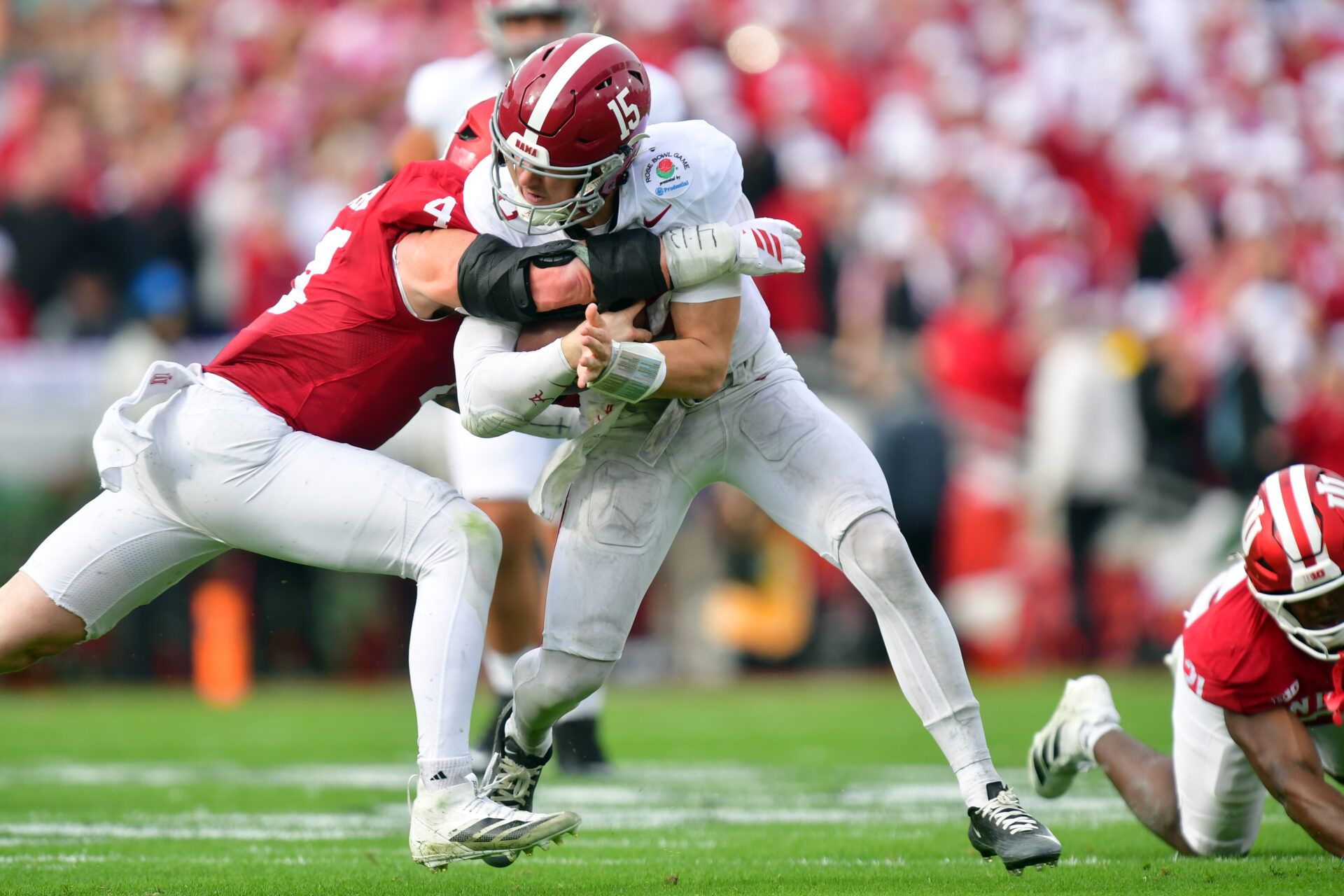 Alabama Crimson Tide quarterback Ty Simpson (15) runs against Indiana Hoosiers linebacker Aiden Fisher (4) in the first half of the 2026 Rose Bowl and quarterfinal game of the College Football Playoff at Rose Bowl Stadium.