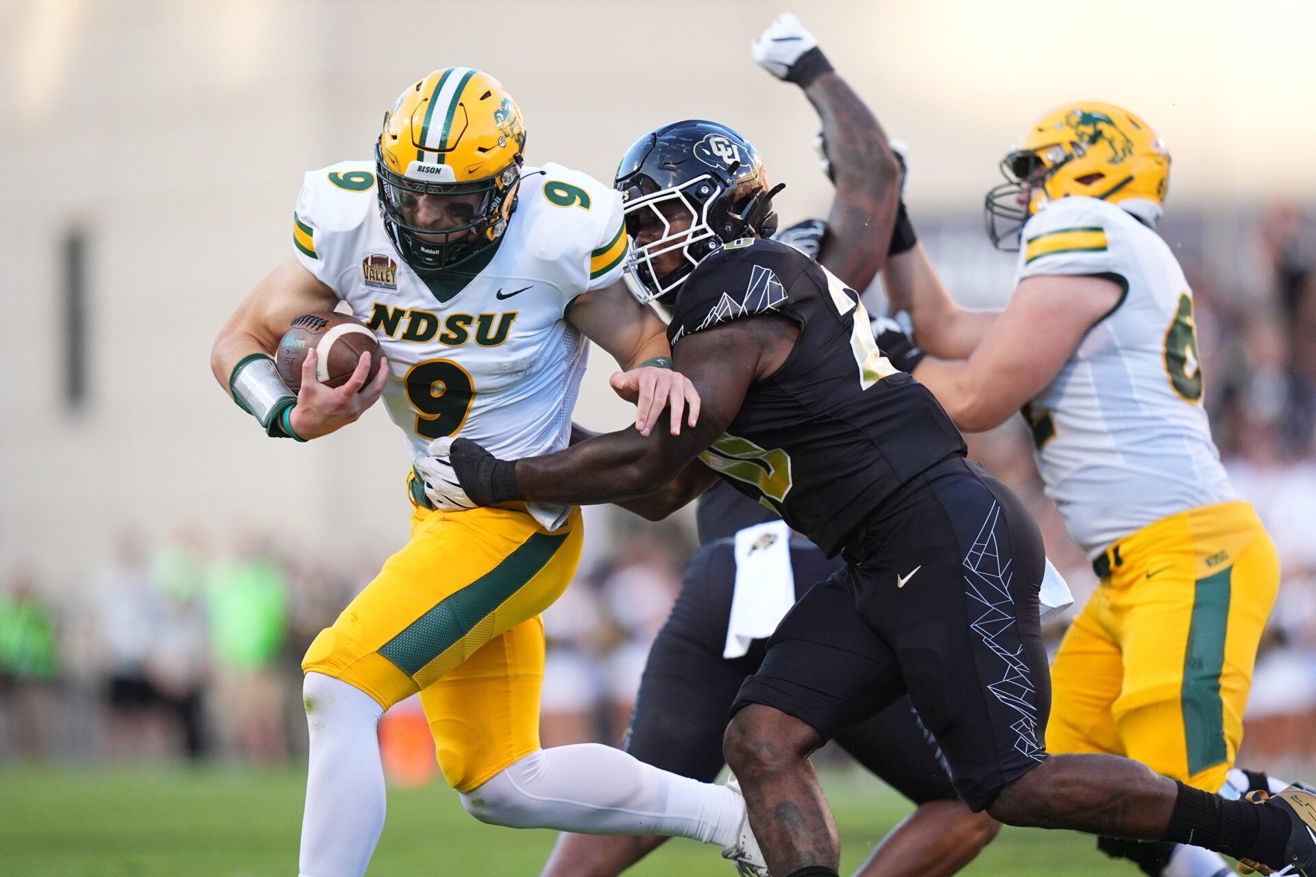 Colorado Buffaloes linebacker LaVonta Bentley (20) tackles North Dakota State Bison quarterback Cole Payton (9) in the first half at Folsom Field.