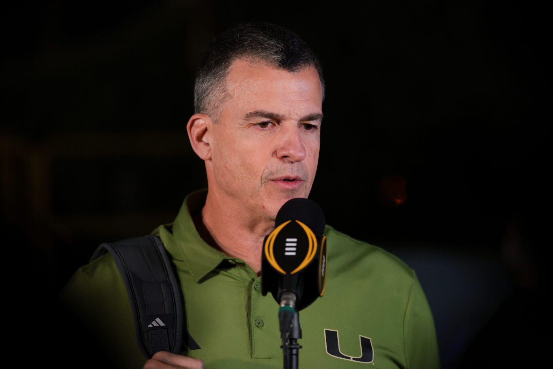 Miami Hurricanes head coach Mario Cristobal speaks to reporters after arriving at the Fontainebleau Miami Beach ahead of the College Football Playoff National Championship game against the Indiana Hoosiers.