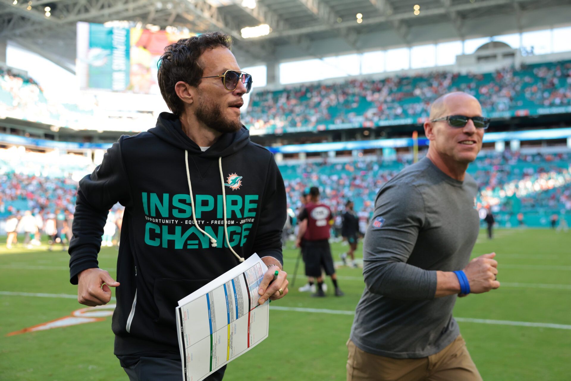 Miami Dolphins head coach Mike McDaniel runs off the field following a win over the Tampa Bay Buccaneers at Hard Rock Stadium.