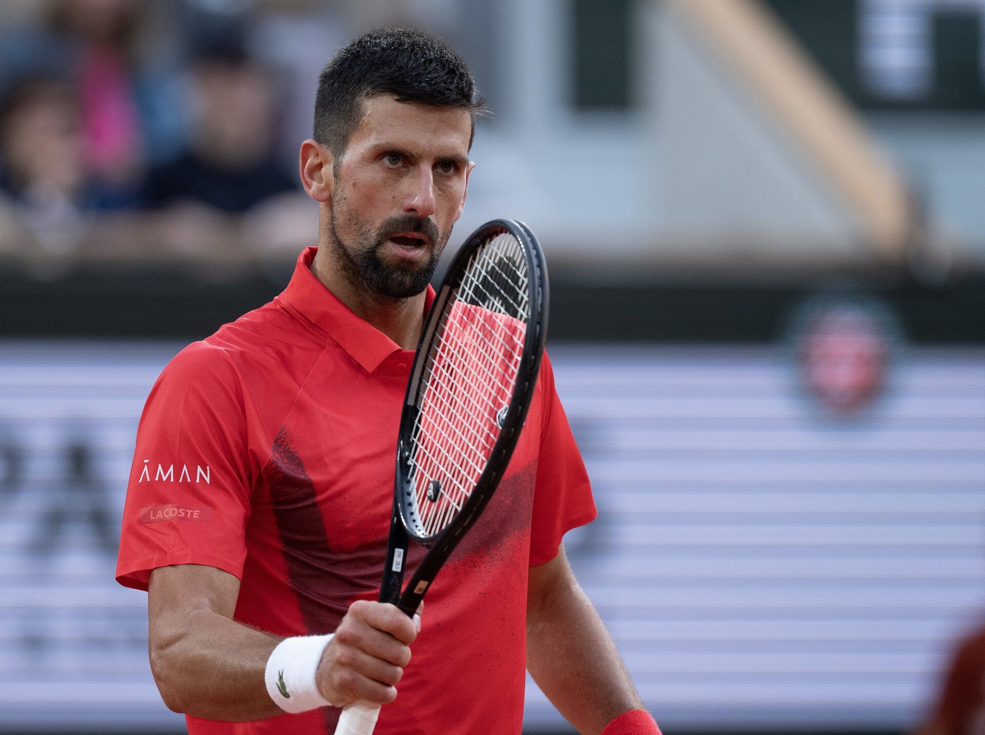 Novak Djokovic of Serbia reacts to a point during his match against Jannik Sinner of Italy on day 13 at Roland Garros Stadium.