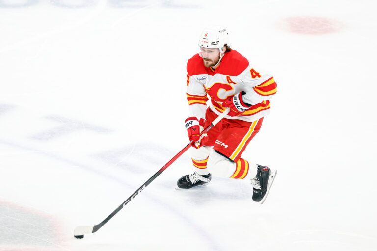 Calgary Flames defenseman Rasmus Andersson (4) controls the puck at United Center.