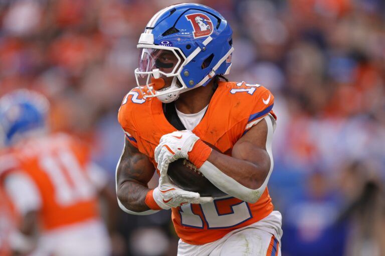 Denver Broncos running back RJ Harvey (12) runs with the ball during the game against the Los Angeles Chargers during the first half at Empower Field at Mile High.